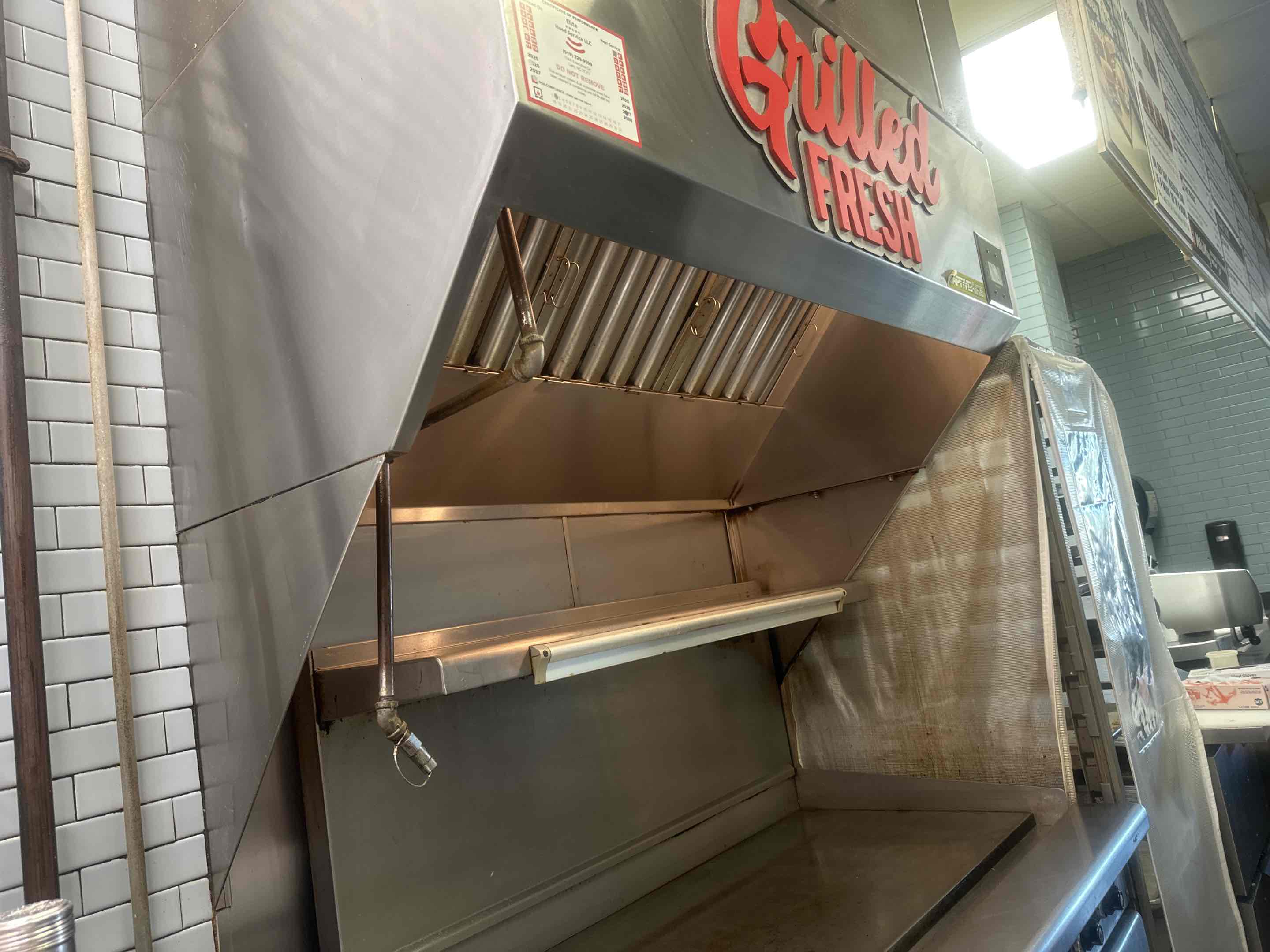 Clean kitchen hood. Started by prepping, putting plastic so grease would fall into a trash can to later be disposed of in a safe manner. Made sure hood fan was working after and everything was clean.