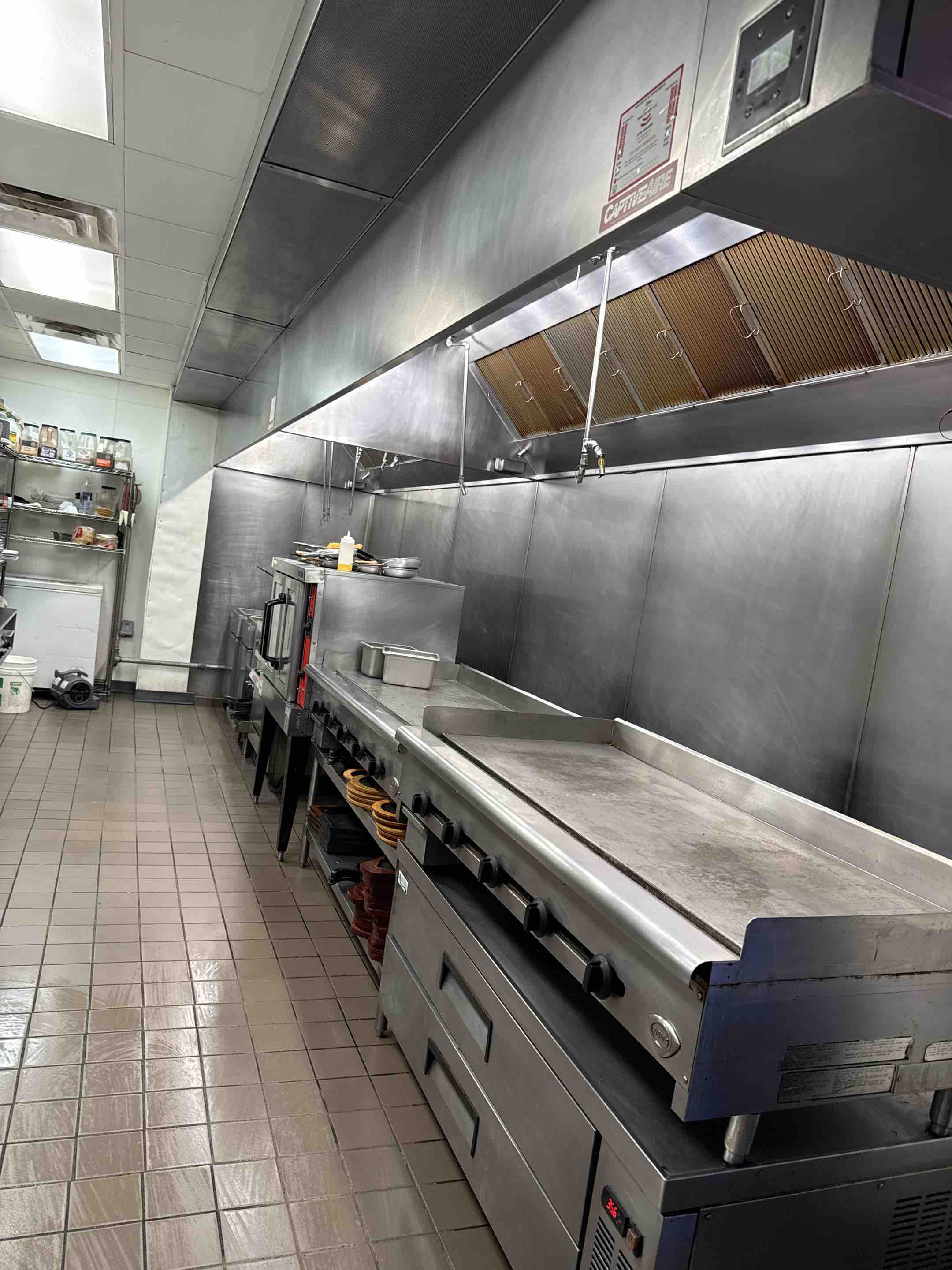 A thorough cleaning of the kitchen hood was performed, starting with a detailed inspection to identify areas with heavy grease buildup. The hood's filters were removed and cleaned using specialized detergents to ensure they were free from any residual grease or contaminants. The interior surfaces of the hood were wiped down with a degreasing solution to remove any accumulated grease and grime. The exhaust fan blades and motor were carefully cleaned to ensure optimal performance and efficiency. After cleaning, all components were reassembled, and a final inspection was conducted to confirm that the hood was operating correctly and efficiently. The entire process was completed with attention to detail to ensure the kitchen hood was restored to its best possible condition.