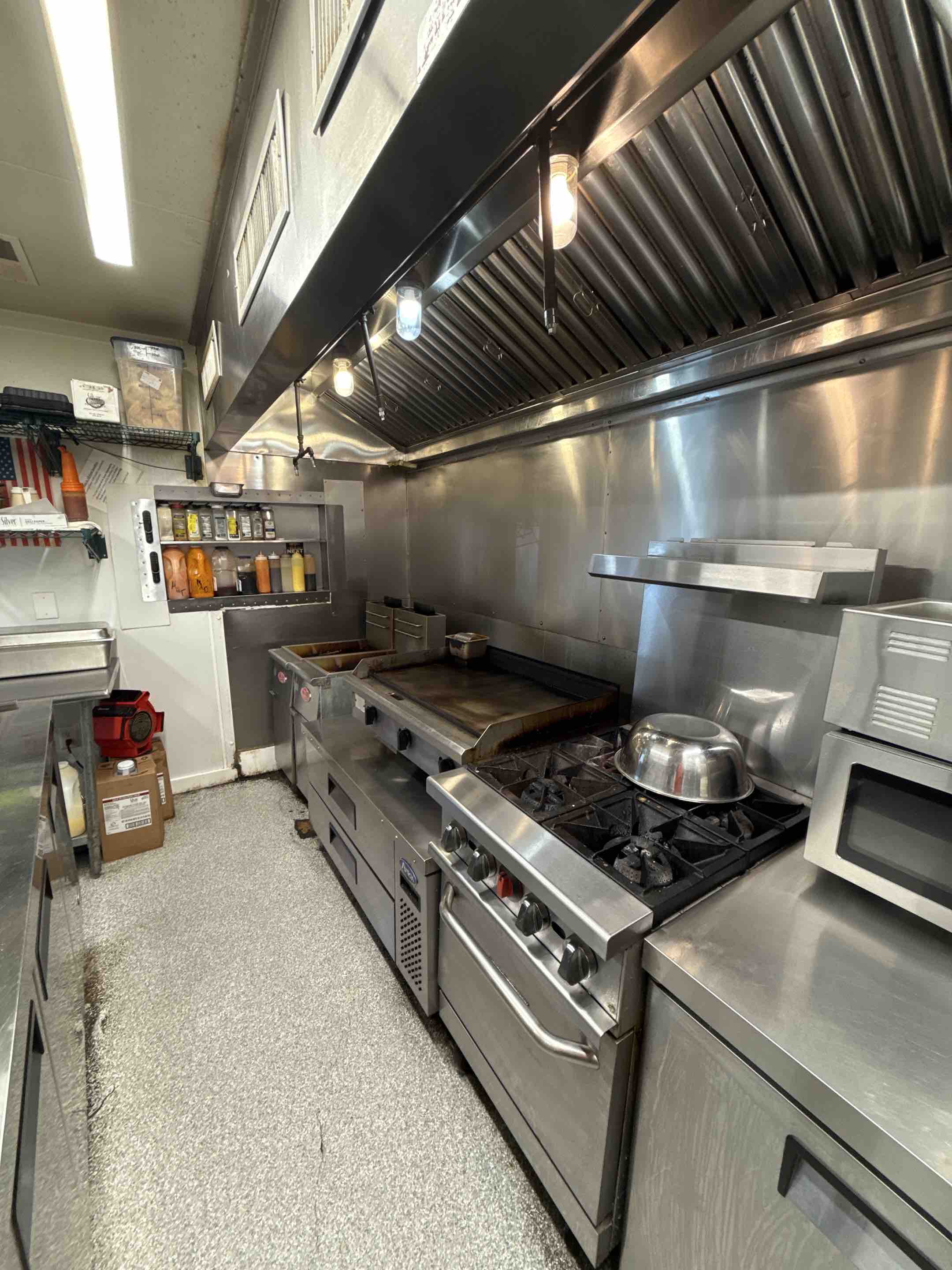A thorough kitchen hood cleaning was performed, focusing on removing accumulated grease and grime from the exhaust hood and ductwork. The process began with a detailed inspection to identify areas with the most buildup. Specialized cleaning agents were applied to dissolve grease deposits, followed by meticulous scrubbing to ensure all contaminants were removed. The hood's filters were cleaned and reinstalled, and the ductwork was inspected for any remaining residue. The final step involved testing the hood to confirm proper airflow and functionality. This comprehensive cleaning ensures the kitchen operates safely and efficiently, reducing fire hazards.