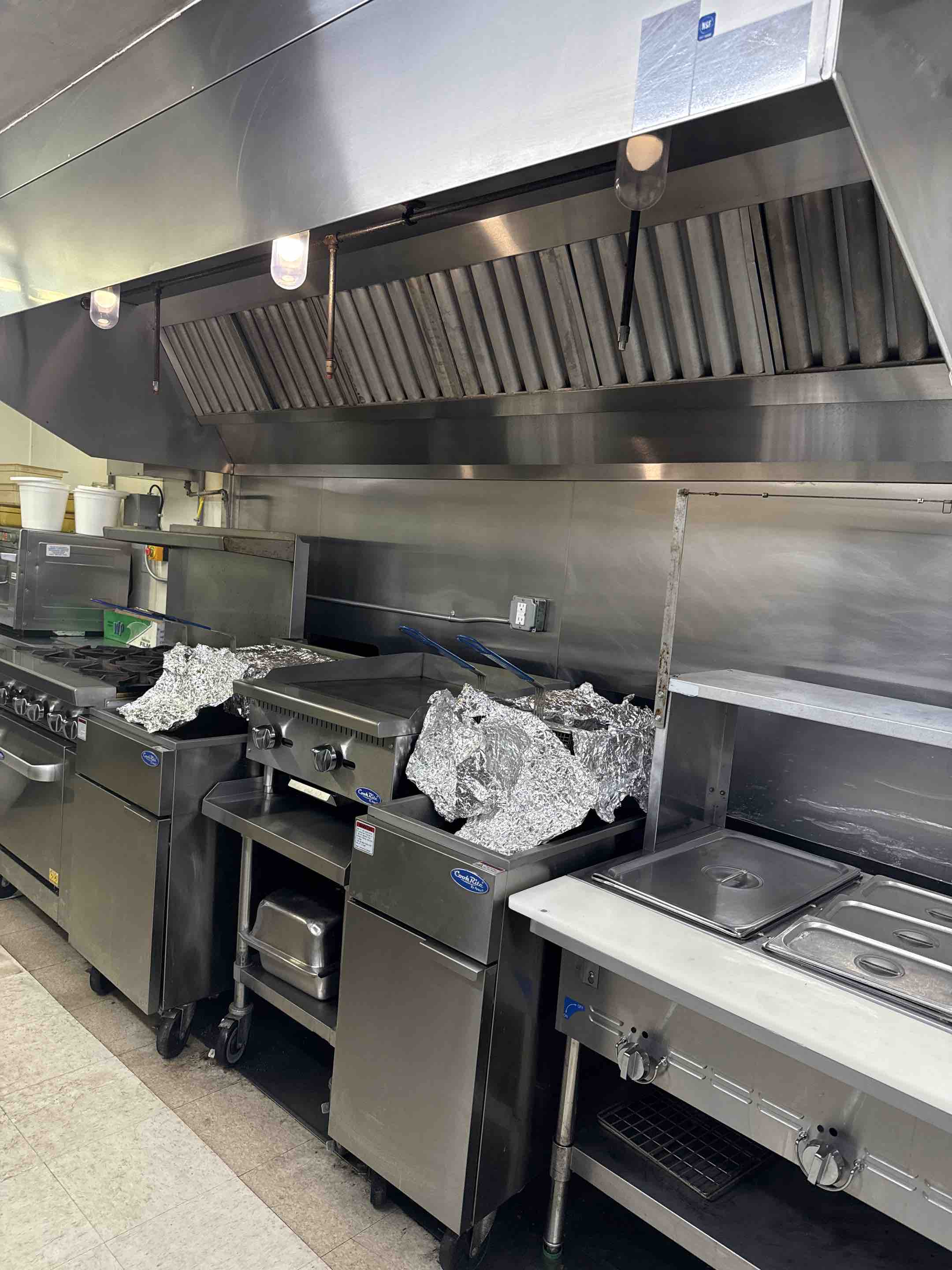 I meticulously cleaned the kitchen hood, starting with a thorough inspection to identify areas with the most buildup. Using specialized cleaning agents, I carefully scrubbed and wiped down the hood's surfaces, ensuring all grease and grime were removed. I paid special attention to the exhaust fan and filters, disassembling and cleaning them to ensure optimal performance. After cleaning, I inspected the hood to confirm all areas were spotless and free of residue. The hood now operates efficiently, contributing to a cleaner and healthier kitchen environment.