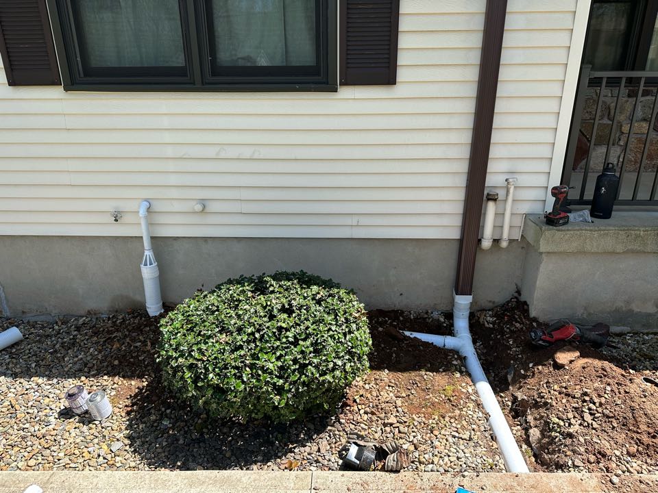 Installed gutter downspouts and sump pump tied underground to discharge into rip rap  