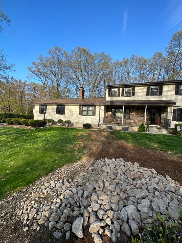Installed gutter downspouts and sump pump tied underground to discharge into rip rap  