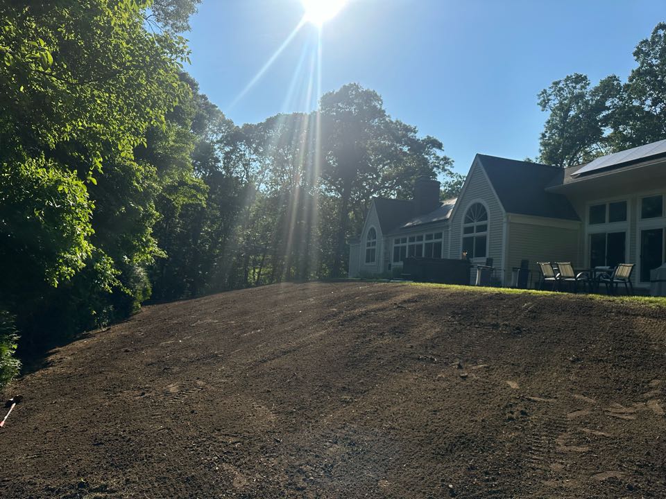 After taking about 2 to 3 feet off the hillside and spreading for tri axles of topsoil. This yard is ready to be Hydroseed tomorrow!