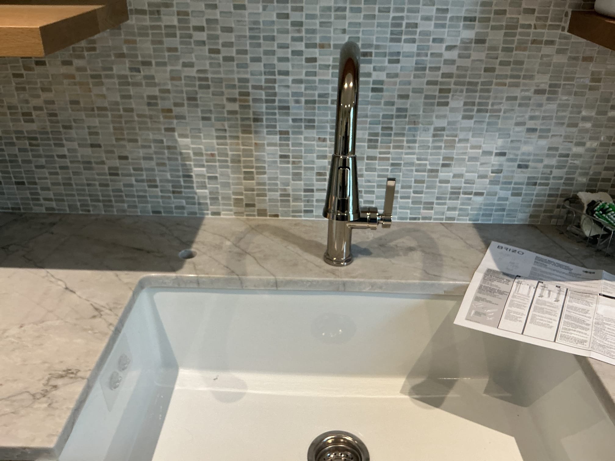 With the countertop now drilled, RO System and faucet are now ready for installation.
Supplied and installed brand new Atlas RO System.
Mounted customer supplied faucet.
Mounted filters on the left and tank on the right of the sink.
Supplied and installed a 1/4 angle stop for the system.
Made up 3/8 and 1/4in hose connections.
Secured all my connections and turned valve on to fill the system.
With the system filled, I heavily purged the system of air.
Manufacturer’s specifications state to let the system run for 15 mins prior to drinking the water.
Ran water and checked for leaks.
There are no leaks at this time.
Drilled hole on tubular tailpiece for rinse of RO System.
There are no leaks on the drain at this time.

*Left all appropriate paperwork on shelf above the sink for the client.