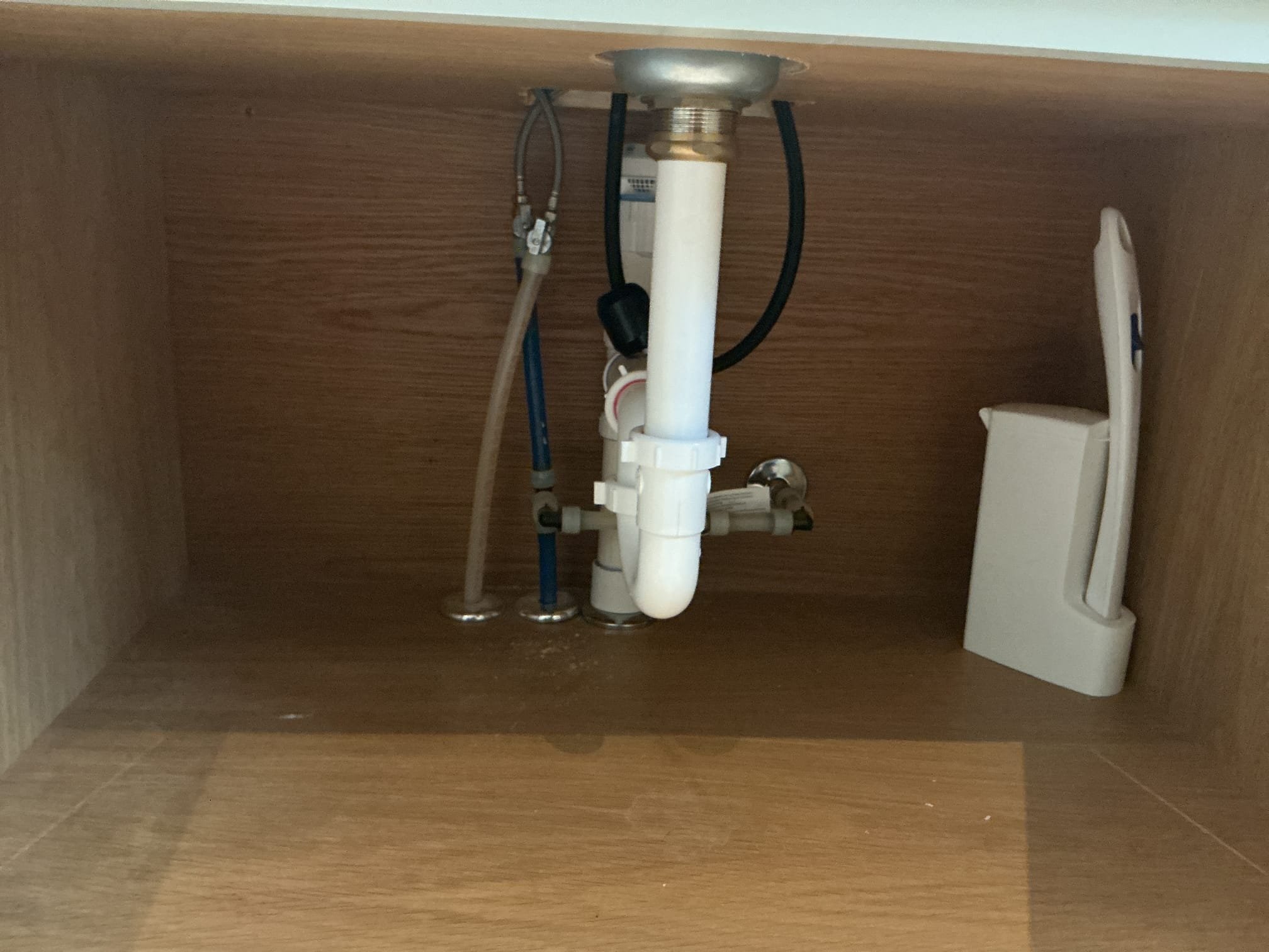 With the countertop now drilled, RO System and faucet are now ready for installation.
Supplied and installed brand new Atlas RO System.
Mounted customer supplied faucet.
Mounted filters on the left and tank on the right of the sink.
Supplied and installed a 1/4 angle stop for the system.
Made up 3/8 and 1/4in hose connections.
Secured all my connections and turned valve on to fill the system.
With the system filled, I heavily purged the system of air.
Manufacturer’s specifications state to let the system run for 15 mins prior to drinking the water.
Ran water and checked for leaks.
There are no leaks at this time.
Drilled hole on tubular tailpiece for rinse of RO System.
There are no leaks on the drain at this time.

*Left all appropriate paperwork on shelf above the sink for the client.