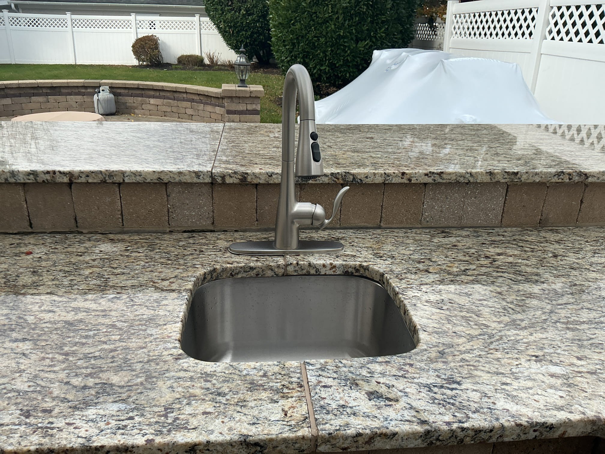 Arrived to the home for winterization of the outdoor sink.
Located shut off valves and boiler drain valves above water heater.
Introduce compressed air of both hot and cold water piping.
Blew out system and emptied all water out of the pipes.
Disconnected supply lines from faucet and left all valves on under the sink.
Poured antifreeze down the drain as well.

Kitchen sink is now winterized