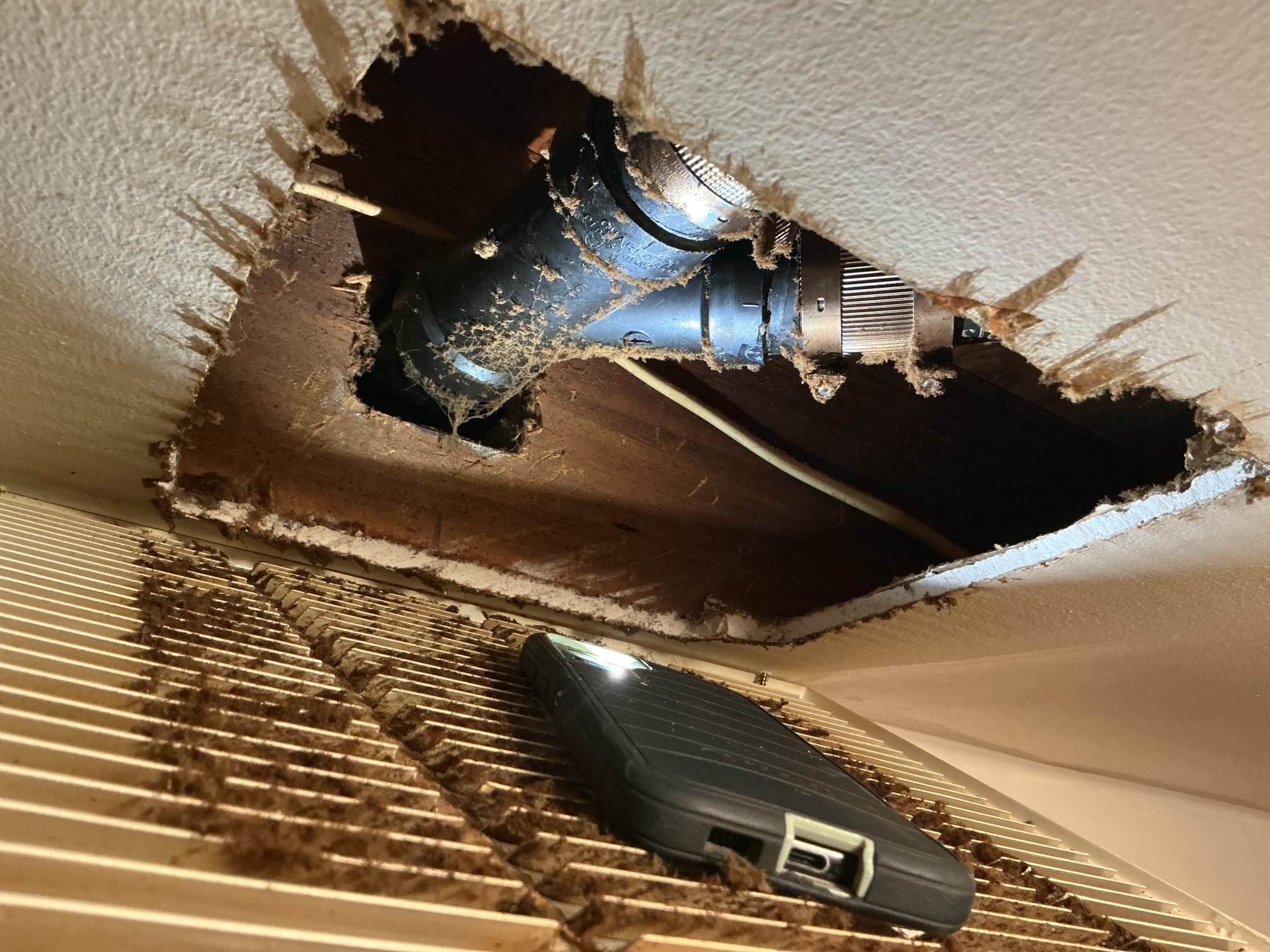 Arrived to the home, customer states there is a leak from the upstairs going down to the first floor, home is a bi level style house. Customer states it leaks worse when the dishwasher is ran in the kitchen upstairs and the leak appears to be coming from the supply register above the fridge on the first floor. After removing the supply register, I discovered an ABS drain pipe has a fracture crack resulting in the leak. After cutting the pipe I discovered a major amount of grease caked up in the piping. With the pipe not be supported correctly the weight of the grease appeared to create the crack. I then spoke to the customer and they would like to go through with the repair.

Cut a portion of the Sheetrock to expose the broken pipe.
Cut out and removed the broken pipe pipe and fittings from the home.
Prepped piping for new install.
Supplied and installed new PVC pipe and fittings.
Supported the piping.
Secured all my connections.
Ran water in both bathtub and kitchen sink to check for 