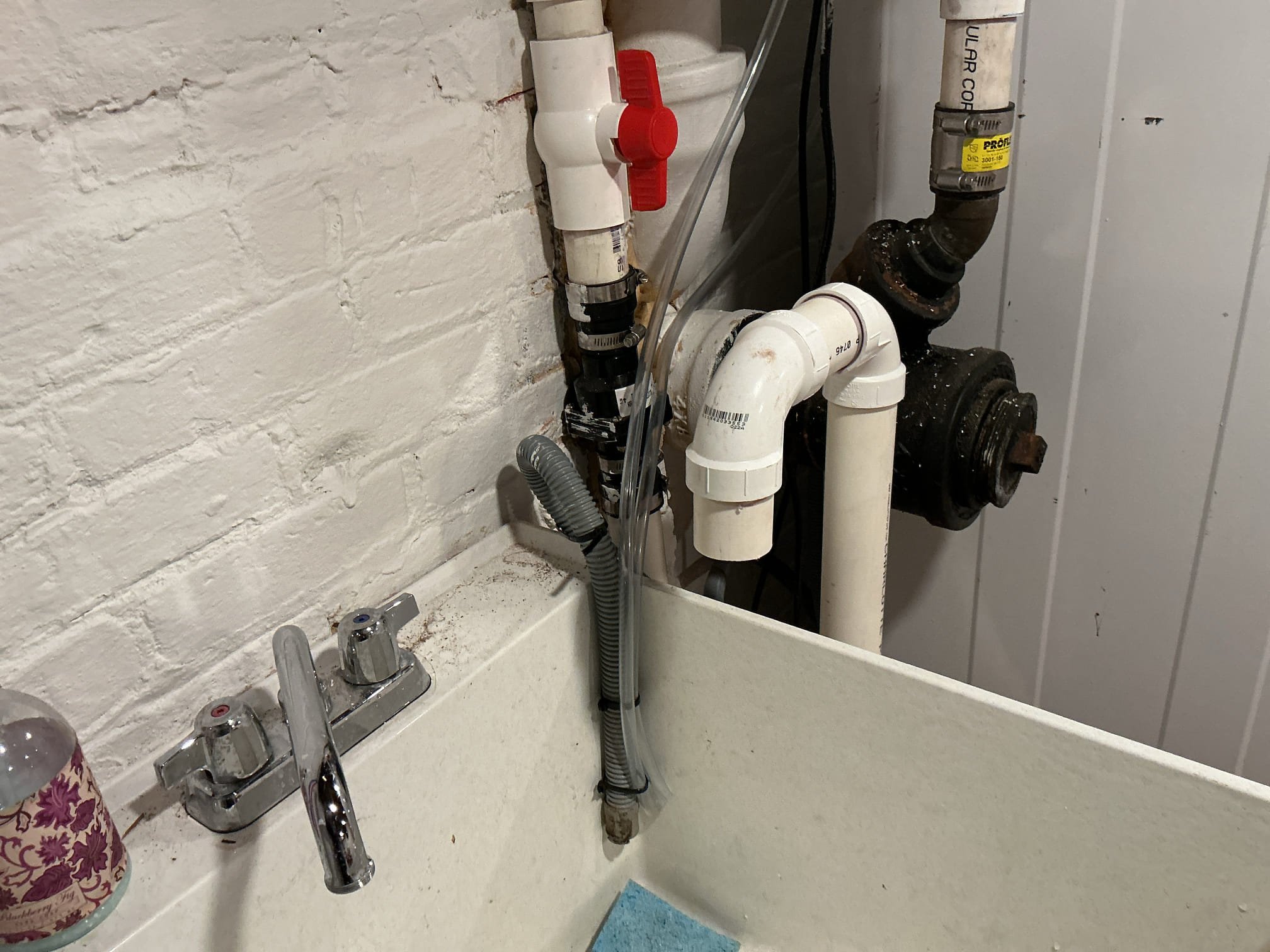 We had recently pulled a permit for an existing laundry sink with a pump in the basement for our client, as per our drawing, we had failed inspection due to there not being a full service ball valve on the discharge and the vent not being connected back to be above the existing sink. Also the condensate piping for the furnace and water heater were to short.

Supplied and installed new full service ball valve for the pump.
Supplied and installed new pvc pipe and fittings to make the vent correct.
Supplied and installed new vinyl tubing for both furnace and water heater and strapped the tubing.
Secured my connections and ran water to check for leaks on the sink.
There are no leaks at this time.

*While on site, client ask if I could attempt to tighten down their existing widespread lav faucet due to it being loose. I attempted to tighten it but the connection will not secure properly due to the gasket being warped. Advised client to replace the faucet.