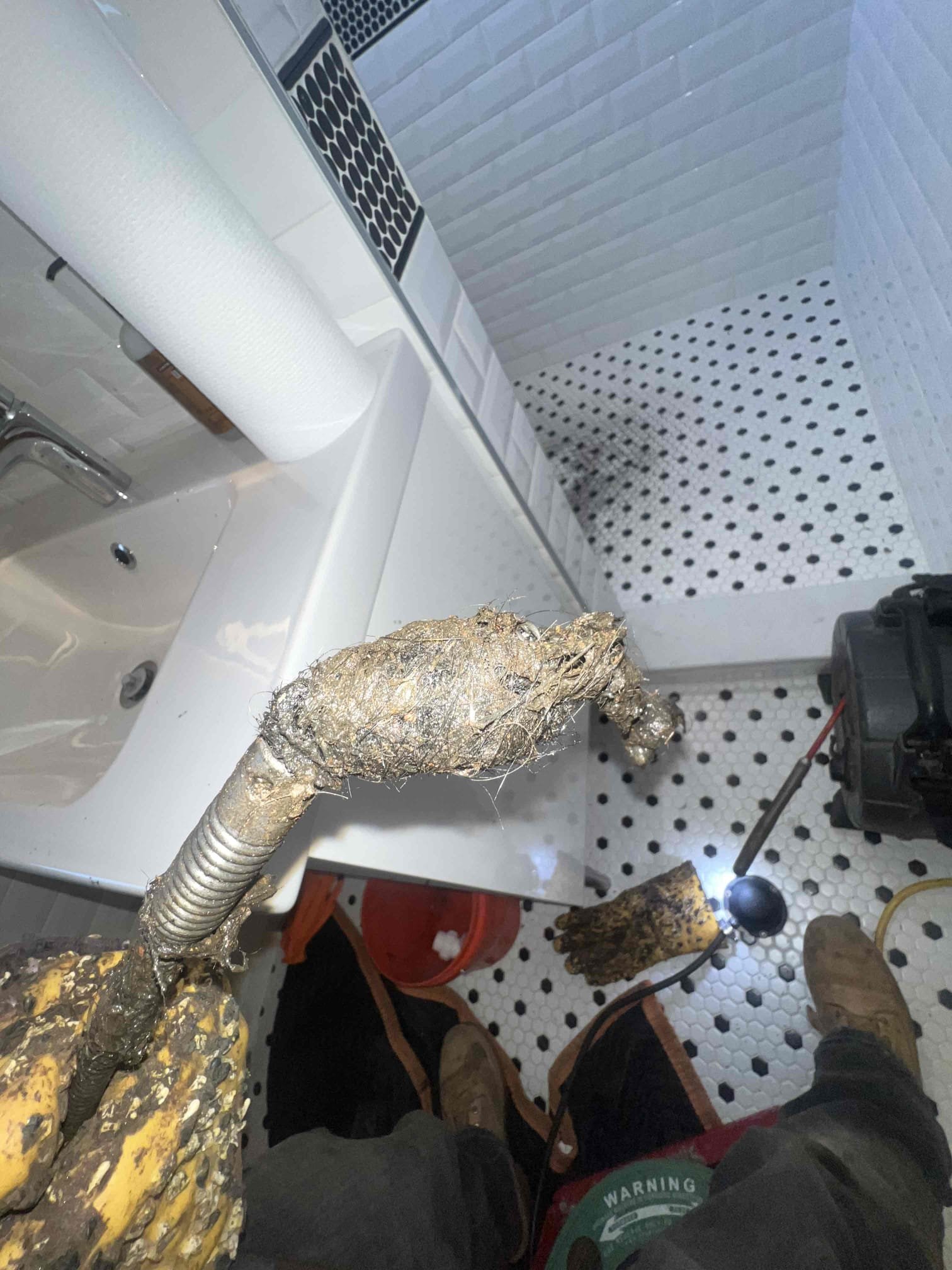 Arrived on site client stated his shower was backing up and when running the upstairs shower it would come out of the downstairs shower. Snaked the shower drain from underneath the lav sink and the water dropped instantly. Ran hot water downstairs at the same time and the shower is now draining as it should.