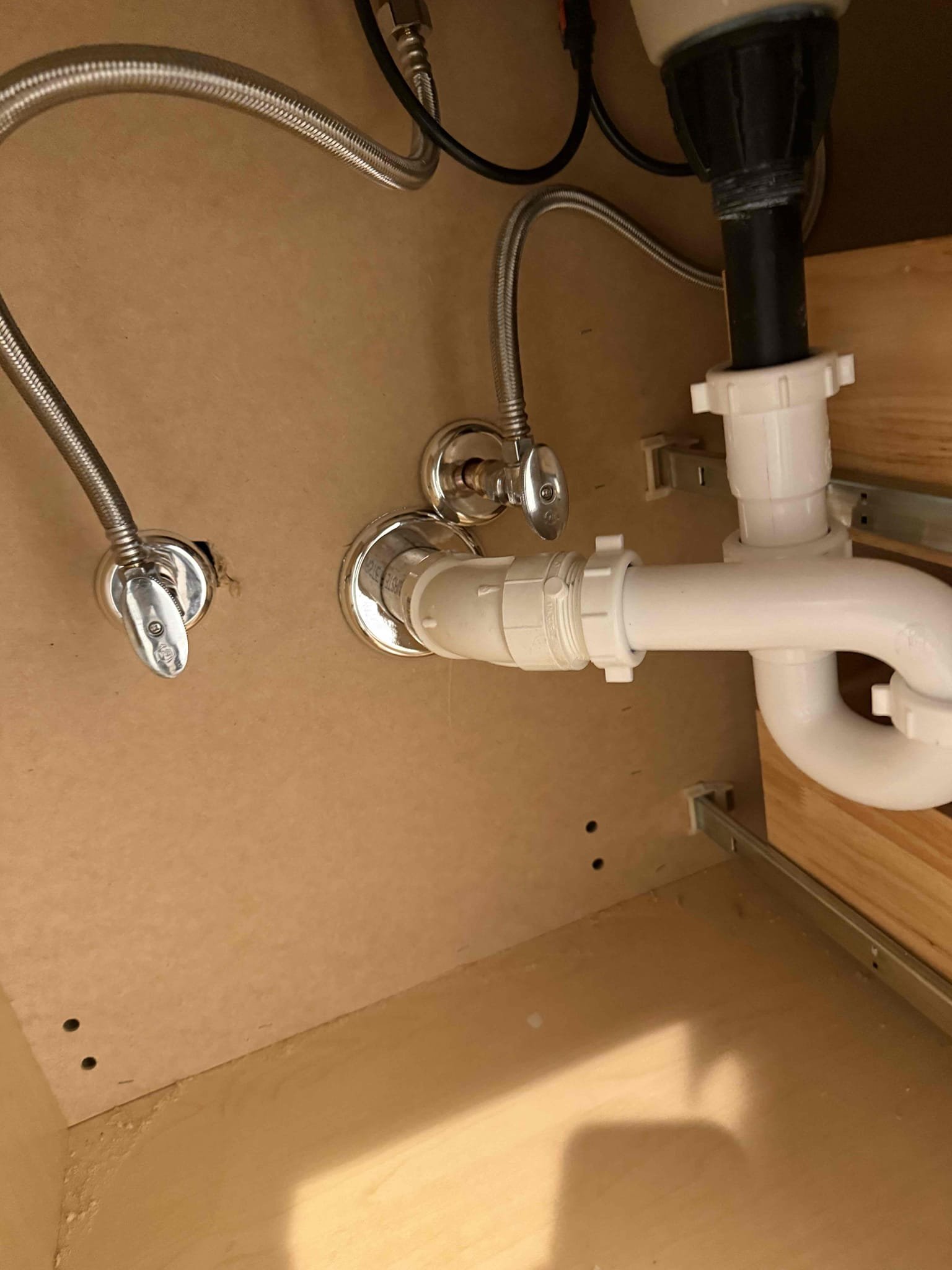 Arrived to home to install customer supplied vanity. Upon inspection found that drainage and water would need to be moved to make vanity fit as best as possible. MyGuy installed customer supplied vanity, customer supplied widespread faucet(reused) and vanity countertop. Did not remove backsplash because customer wanted to keep it there. MyGuy supplied faucet supply lines and also drainage fittings, copper fittings for faucet and straps to secure lines. While installing, wall was not perfectly square causing a slight increase in gap width on right side of vanity. We silicone countertop to vanity base after securing base to wall studs. Also used white caulk to fill gaps. Tested for leaks on all work and there are no leaks at this time.