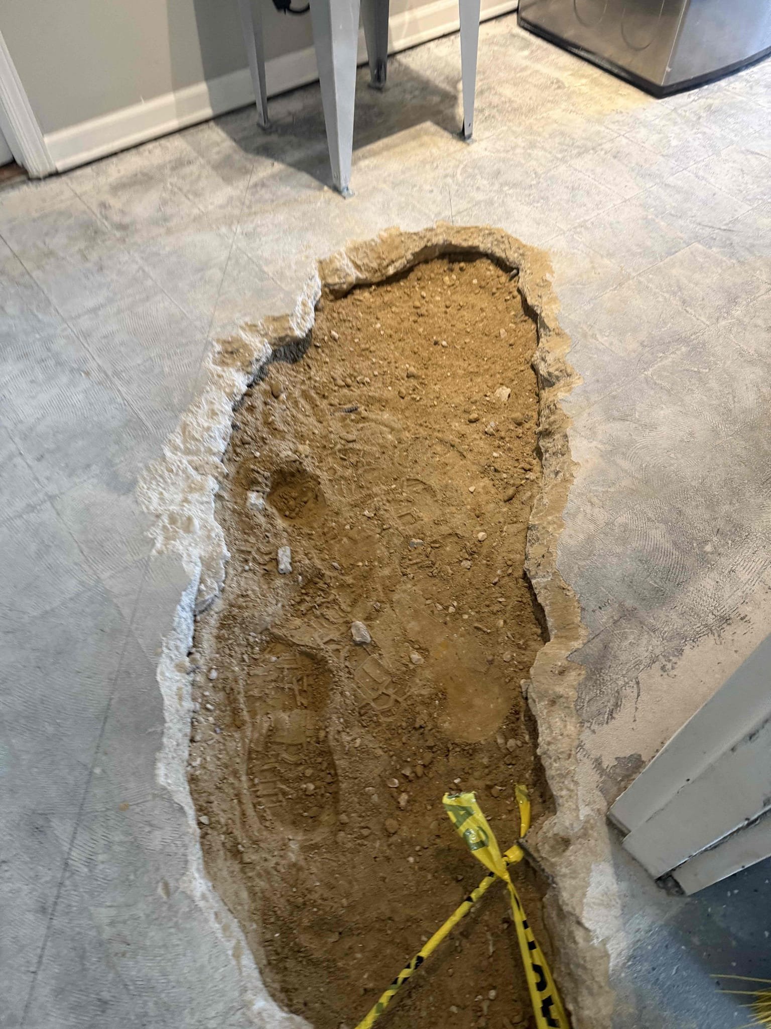 Repair pipe under slab
Arrived to home to remove section of slab and replace 2” drainage. We demo slab, removed old cast iron pipe which was very backpitched and also almost completely full towards end of run. Cut out line, used flex shaft to clear out remaining we did not touch. . Line is clear, we replaced with solid core pvc and pitched accordingly. Filled sink multiple times and tested for leaks, there are none at this time. MyGuy is not responsible for replacing concrete that was removed to perform work. I wrapped caution tape around exposed rebar to avoid tripping. MyGuy is not responsible for any slips falls or injuries if someone is to do so around exposed hole. 