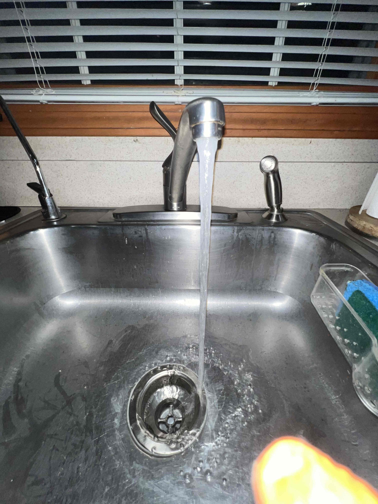 Arrived on site client stated her kitchen sink was backing up and she had a crack in a pipe below the kitchen sink. Upon inspection client had a crack on one of the nuts and we also noticed the basket strainer was old and rotting away. Clients kitchen line in the basement was slightly bellied. Today we replaced the basket strainer, 3/4 dishwasher tailpiece, and trap underneath as well as hydrojetting the kitchen line and strapping it in the basement. Tested for leaks under the sink and tested for kitchen sink flow. There are no leaks and the kitchen sink is now draining as it should.