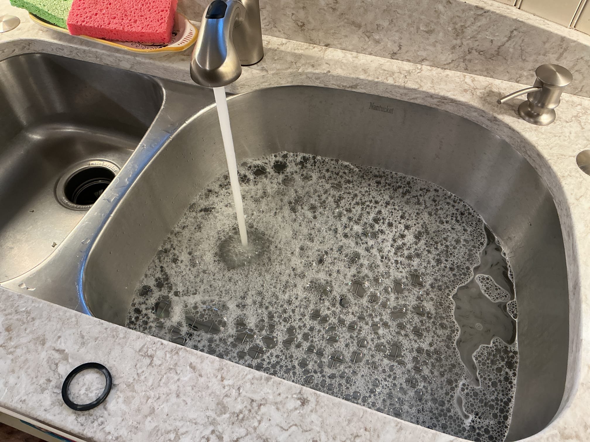 We had recently installed a new basket strainer under the kitchen sink, we arrived today due to the client stating there is a leak coming from it. I ran the faucet and discovered that the leak is not from the strainer but from the connection to the flanged tailpiece. I installed a new top hat washer and pressure tested the sink 3 times to check for leaks. There are no leaks at this time.