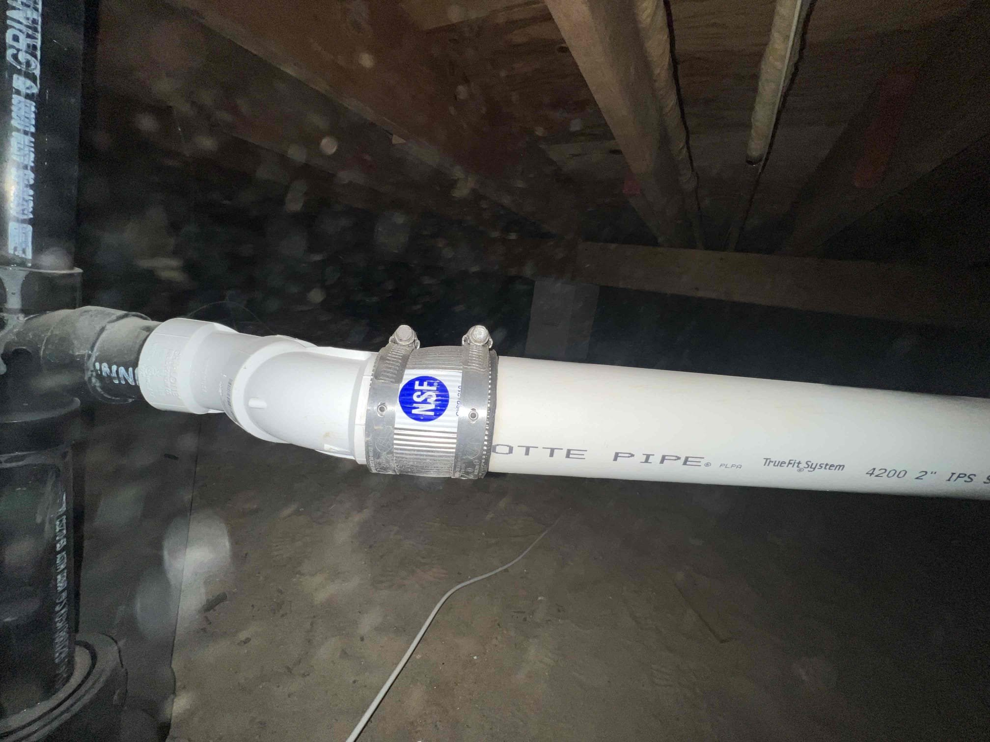 Arrived on site to perform plumbing inspection. Upon inspection in the crawlspace I noticed a section of pipe where the kitchen drops into the main there is a belly and the 4” main is not strapped. Also on the kitchen line there is a no hub coupling being used as a reducer where it goes from 2” to 1 1/2 and the 4x3x4 tee wye is on its back. Also when going in the garage to check out the heater and boiler there was a slight drip on a gate valve by the water heater that has a bleeder cap on it. 