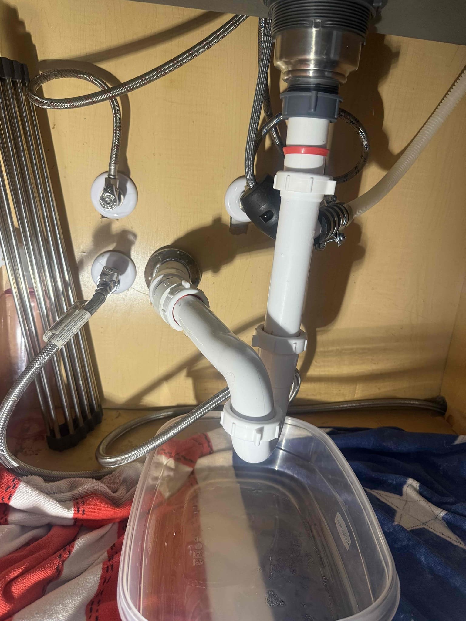 1 item under kitchen sink
Arrived to home for leak under kitchen sink. Upon inspection found that tubular joint popped. Drain had play and was backpitched. Someone had bent tubular arm to try and correct pitch. Recommend cutting out incorrectly installed 45 angle fitting and redo all drainage up to basket strainer. 
Today MyGuy supplied and installed new bag trap and used greeenfield hanger to correct pitch without cutting out existing 45 fitting. Drain is now pitched and all connections are tight. 
***bottom of cabinet is completely saturated, soft and warped. While working my elbow caused damage. I let customer know and they are aware. Recommend hiring carpenter to replace before mold is able to grow.