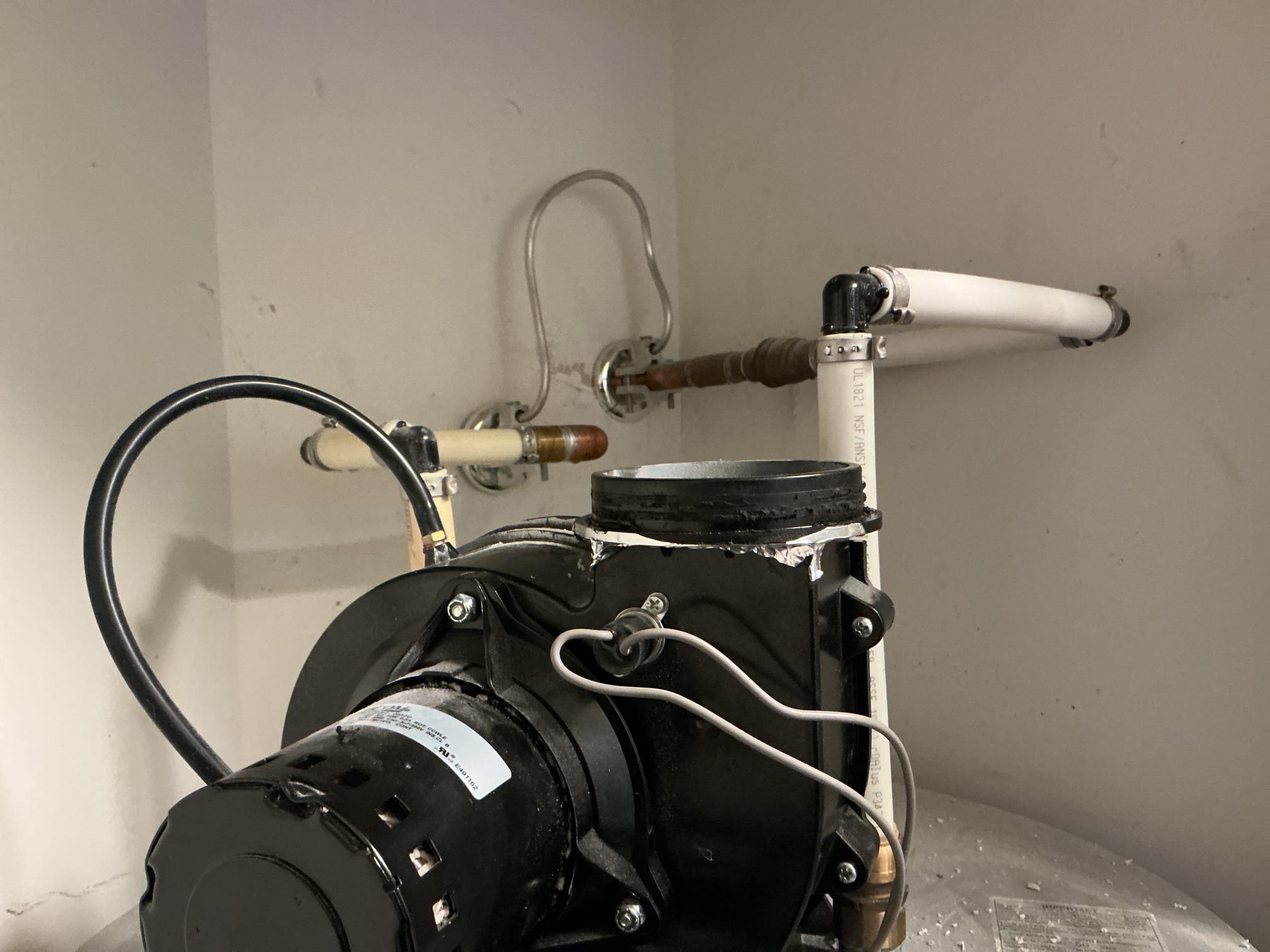 Arrived to the home, customer has an existing power vent water heater that the pvc flu piping had broken apart. Client had then cut the Sheetrock above and wrapped all the piping in foil tape. After providing options, client would like to go through with the work quoted. I then grabbed the material needed for the repair and returned back to the home. After removing the foil tape, I had then discovered that the water heater is missing a very critical connection to the top of the blower which is the rubber exhaust adapter. Whoever had installed this water heater used a no hub coupling instead, and the no hub has melted and broke apart. I advised to the client that I need this specific part in order to make the repair. I have reached out to our warehouse manager and they are ordering the part for the client. We will need to make a return trip next week once the part comes in, in order to properly repair the flu piping. Client is aware and fully understands the issue at hand. I am acceptin