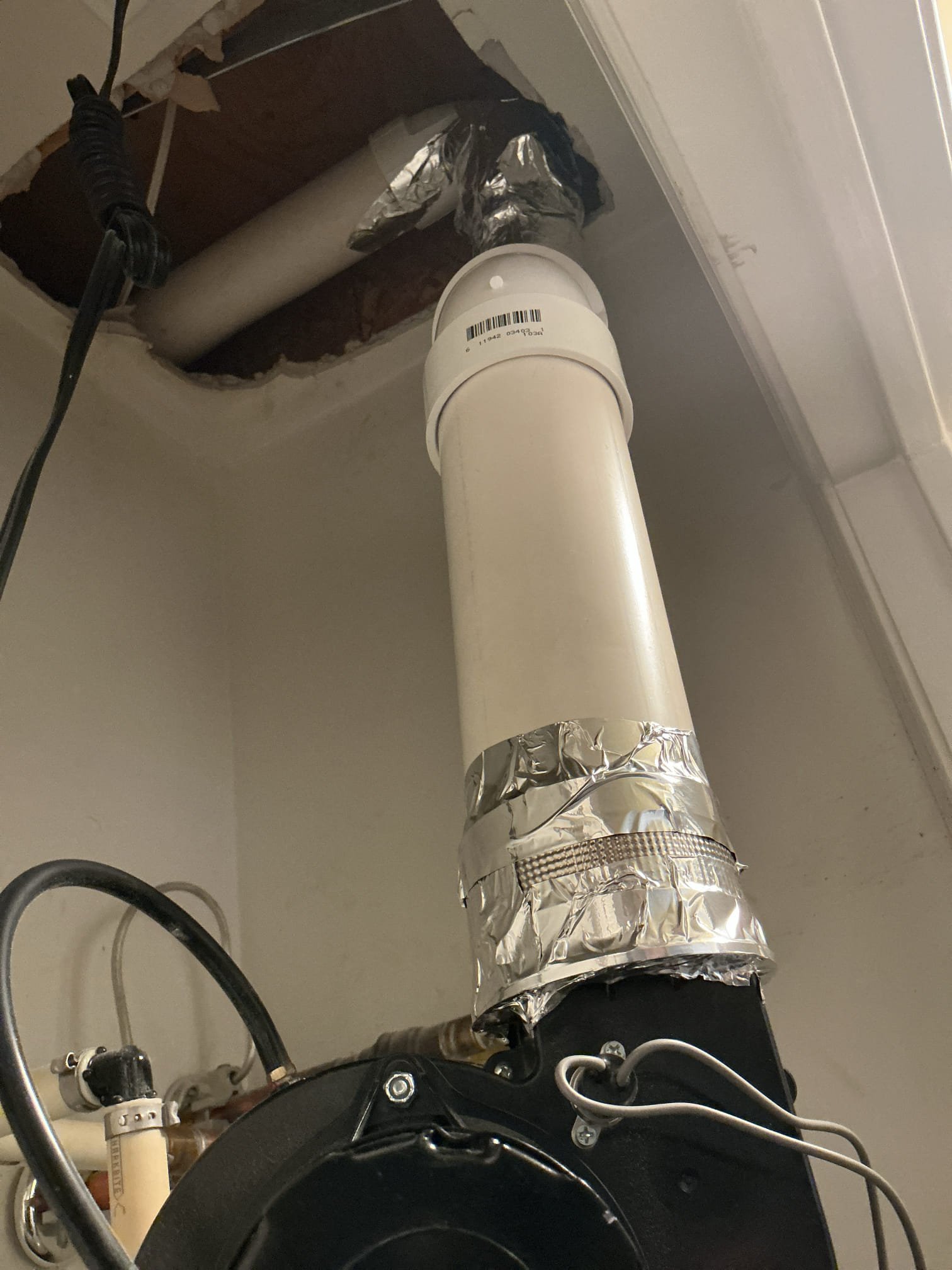 Arrived to the home, customer has an existing power vent water heater that the pvc flu piping had broken apart. Client had then cut the Sheetrock above and wrapped all the piping in foil tape. After providing options, client would like to go through with the work quoted. I then grabbed the material needed for the repair and returned back to the home. After removing the foil tape, I had then discovered that the water heater is missing a very critical connection to the top of the blower which is the rubber exhaust adapter. Whoever had installed this water heater used a no hub coupling instead, and the no hub has melted and broke apart. I advised to the client that I need this specific part in order to make the repair. I have reached out to our warehouse manager and they are ordering the part for the client. We will need to make a return trip next week once the part comes in, in order to properly repair the flu piping. Client is aware and fully understands the issue at hand. I am acceptin