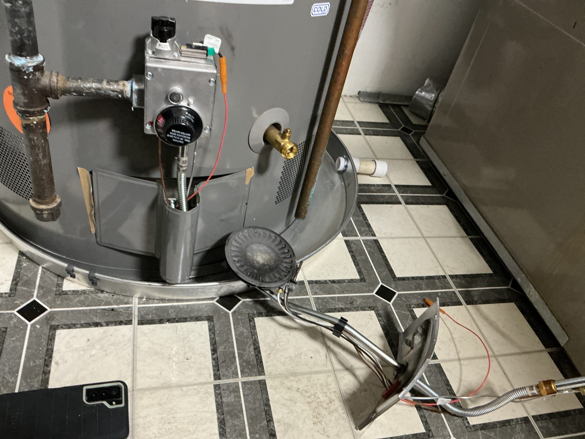 Arrived to the home, for no hot water, existing water heater is not even 1 year old. I first attempted to light the water heater and I was able to do so, but I discovered that the burner assembly was not engaged properly on the anchor, resulting in a huge flame in the chamber. Also the flame was not heating the tank properly resulting in the water heater not being efficient. I provided options to replace the door and pilot assembly. With the new parts in, I was able to get the water heater to light but then it slowly goes out. I next discovered that the gas valve stops producing gas when it is on. I also need to replace the gas valve at this time. Due to the holiday, no supply house is open at this time. We have squeezed our client on the schedule for this Friday morning first to replace the gas valve.