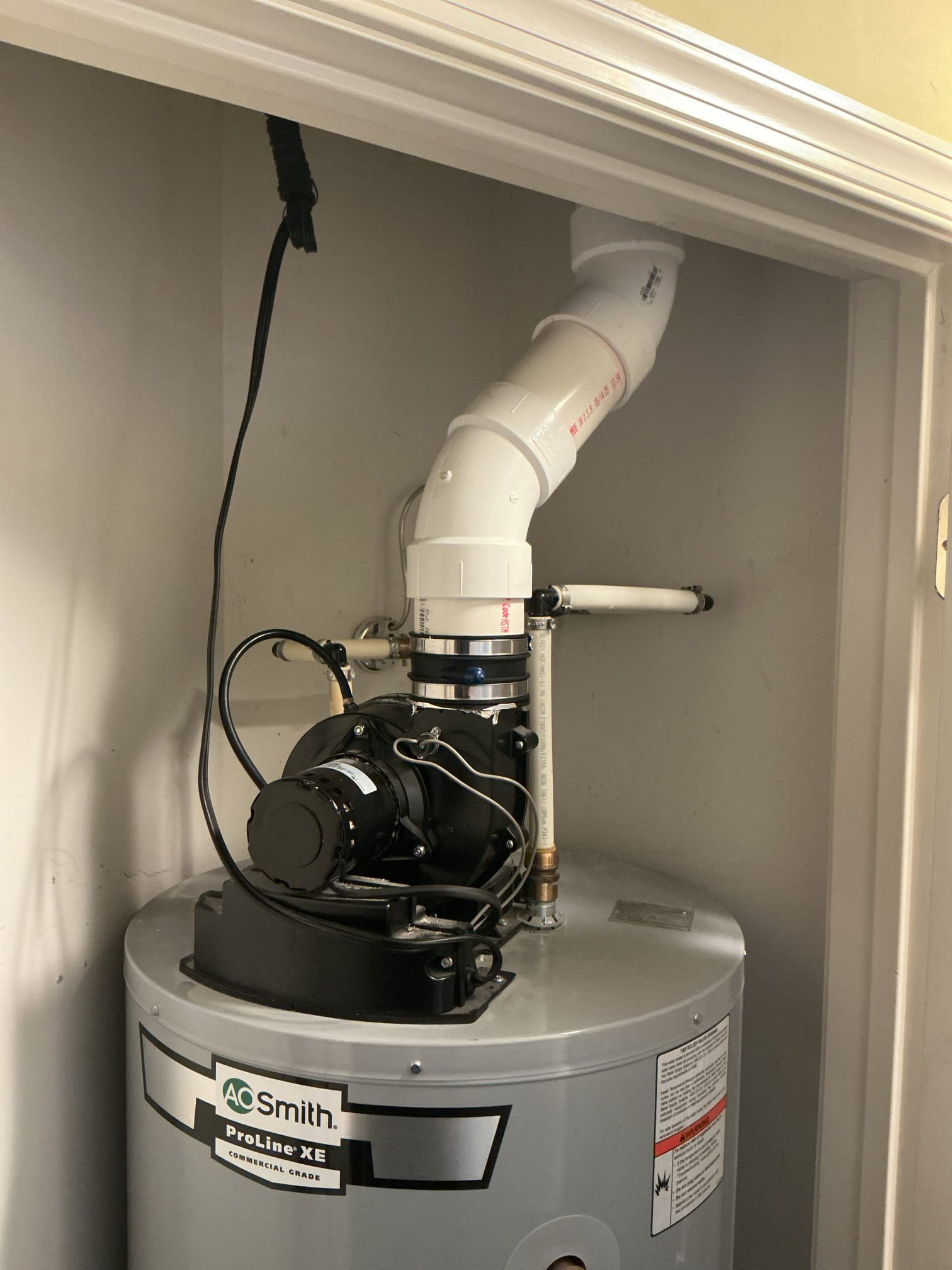 Arrived to the home to fix the existing flu for the power vent water heater. A special fitting is required to connect the pvc piping correctly. I have arrived back on site to repair the flu piping properly.

Cut out existing pvc piping.
Supplied and installed new solid core pvc pipe, fittings, and special exhaust adapter.
Secured all my connections and turned the power vent back on to check for leaks.
There are no leaks at this time.