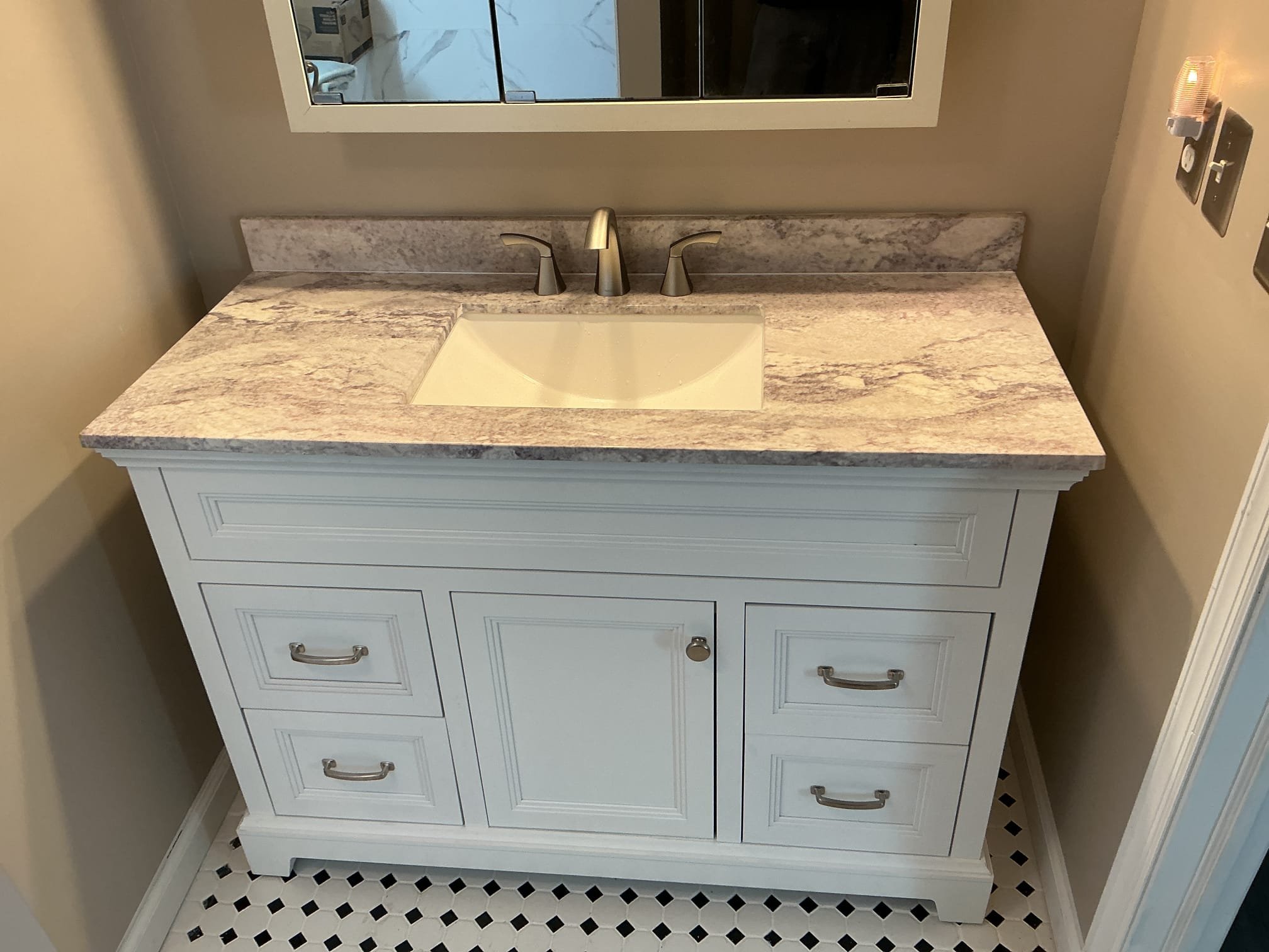 Installed customer supplied vanity and widespread faucet in master bedroom.
Cut Sheetrock on the left side of the vanity to access the drain.
Installed drain piping through the cabinets and in between the drawers.
Installed new shut off valves for client.
Secured all my connections and turned the water on and pressure tested the sink to check for leaks.
There are no leaks at this time.

*Warranty on valves and tubular supplied by MyGuy Plumbing.
*Can not warranty customer supplied parts.