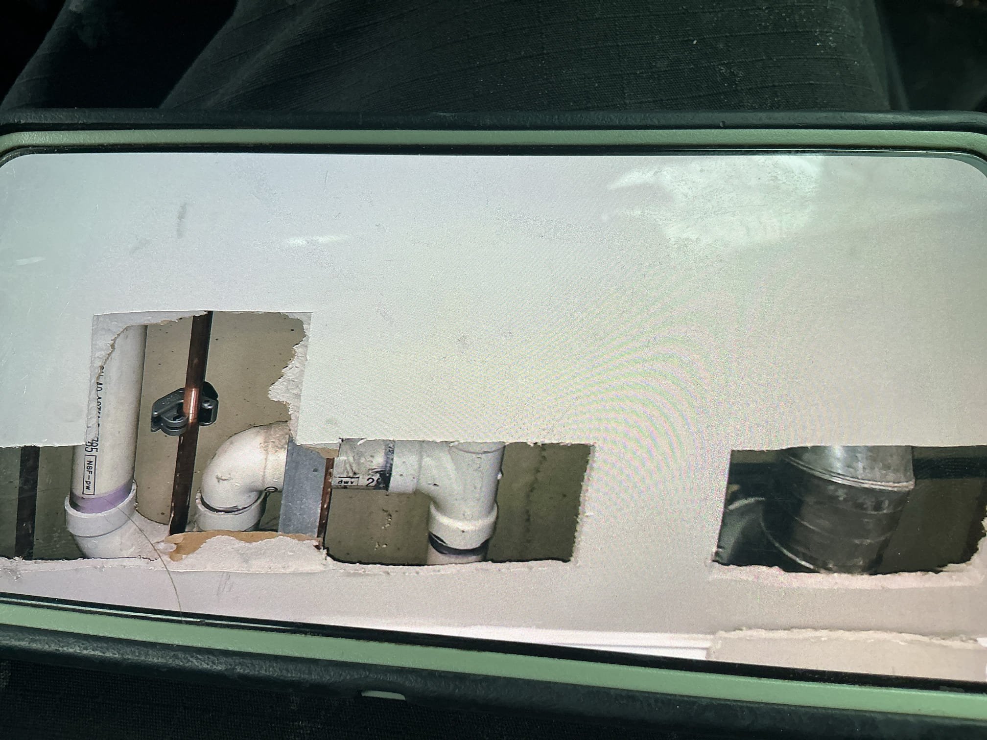 Arrived to the home for a mystery leak somewhere from the upstairs laundry room. Client has had multiple companies out including roofers, plumbers, and dryer vent specialists to try and find the leak. Client had cut many holes in the upstairs bedroom and a small hole on the first floor to fine to leak. I was able to see the copper risers for the washer box from the bedroom and they were all dry. I advised to the client to let me first cut a hole below the riser to see if there are any other leaks. After cutting the hole I discovered the hot side riser was very corroded while the cold was fine. I asked the client if they have had any work done in the bedroom recently. They advised me that they had the flooring done about 4years ago. I then let the client know to let me cut and removed the corroded riser to see if there is a pinhole or anything of the sort. 

Turned off water to the home.
Drained down the system.
Cut out and removed corroded pipe.
Discovered that a finish nail had penetr