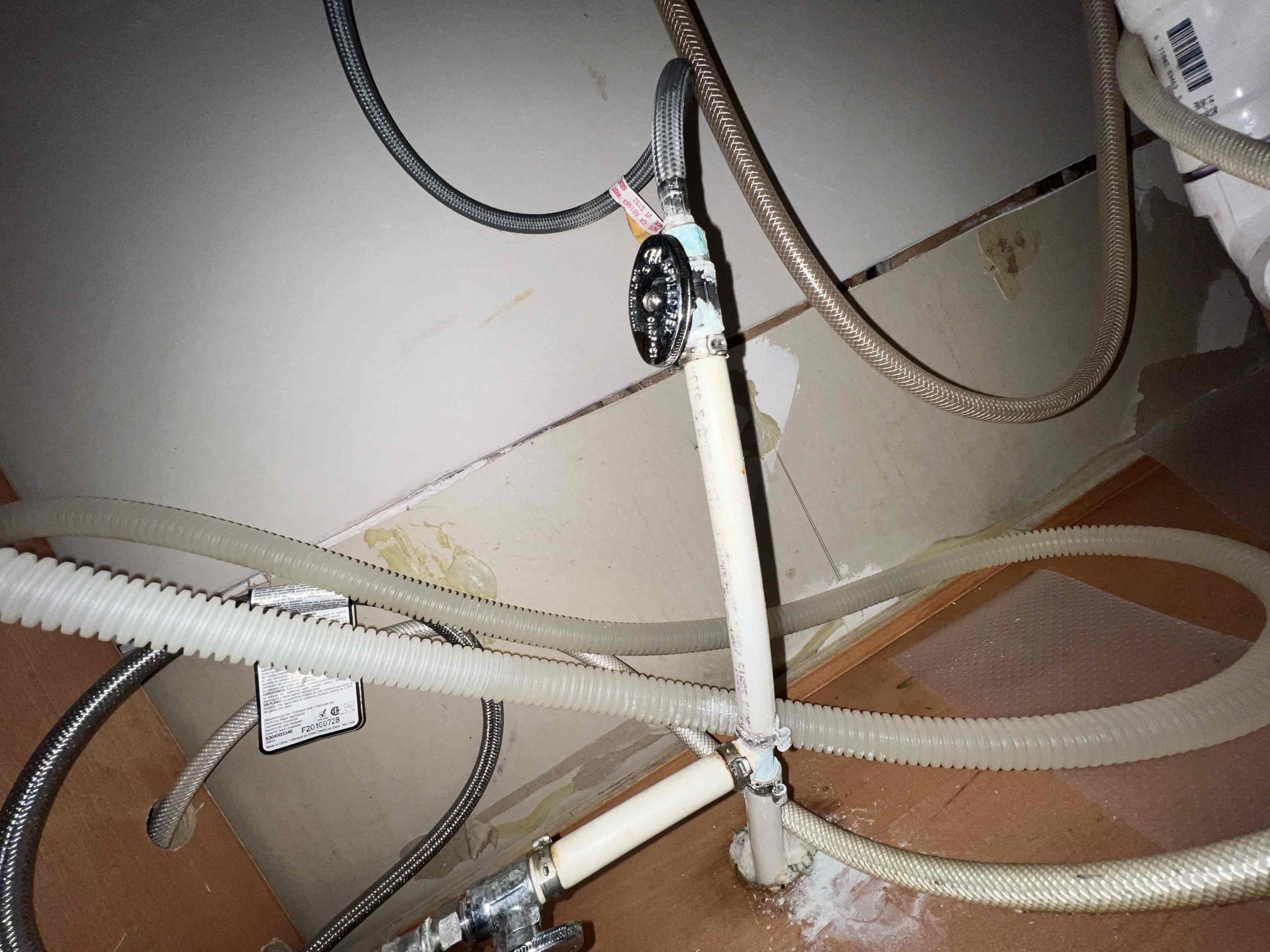 Arrived on site to a possible recall. Upon inspection the nut below the dishwasher tailpiece appeared to be cross threaded so I replaced the nut and it is no longer leaking. Client brought to my attention that she thinks the ice maker to her fridge is leaking so she would like for us to remove the valve for the icemaker. Since the icemaker and cold side for the faucet share the same valve I have to replace that valve and remove the tee fitting. Since all valves appear to be old and corroded client felt it was a good idea to replace all of them under the kitchen sink. The nut on the hot side supply line for the faucet broke as I tried removing it and since it is an integral part we had to replace the faucet as well. When done I tested all connections for leaks with hot water and there are no longer any leaks.