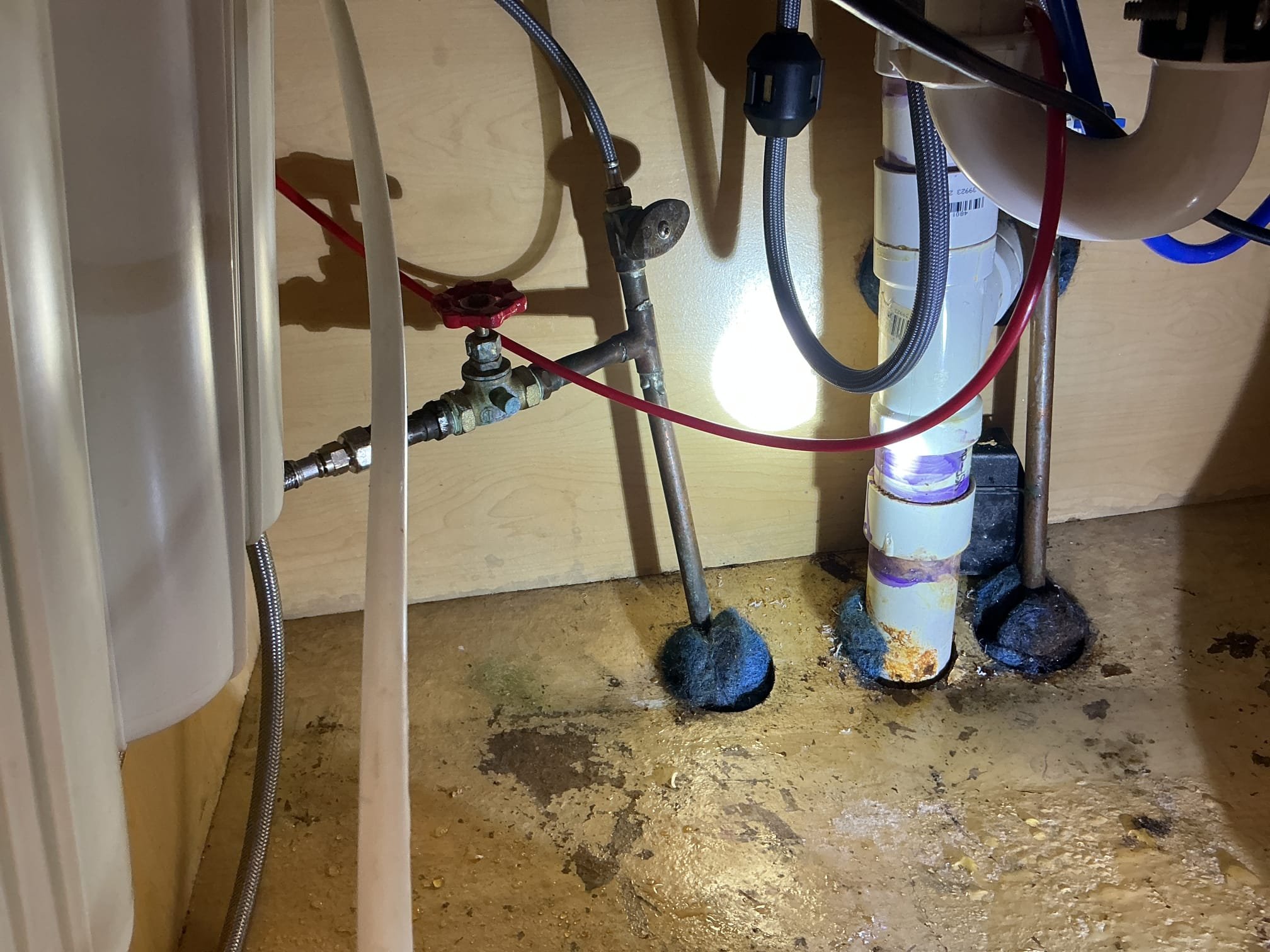 Arrived to the home, we had recently installed new tubular drain piping for the client, we arrived today due to a leak under the kitchen sink. At first glance, I could not see any leaks. I first started to run the faucet and dishwasher, and I can not recreate any leak. I next checked the Ro system and everything seem to working fine. I removed a shelf on the right side of the cabinet that the client uses for storage, and I discovered and active leak coming from the shut off valve and the wood under it is completely saturated. I called the client in and showed them the active leak. The two other valves on the hot side are not leaking at this time, but show signs of corrosion. I provided options for replacement of just the leaking valve or replacement of all the valves, client would like to replace all the valve under the kitchen sink.

Turned off the water to the home.
Drained down the system.
Cut out and removed existing shut off valves from the home.
Supplied and installed new straigh