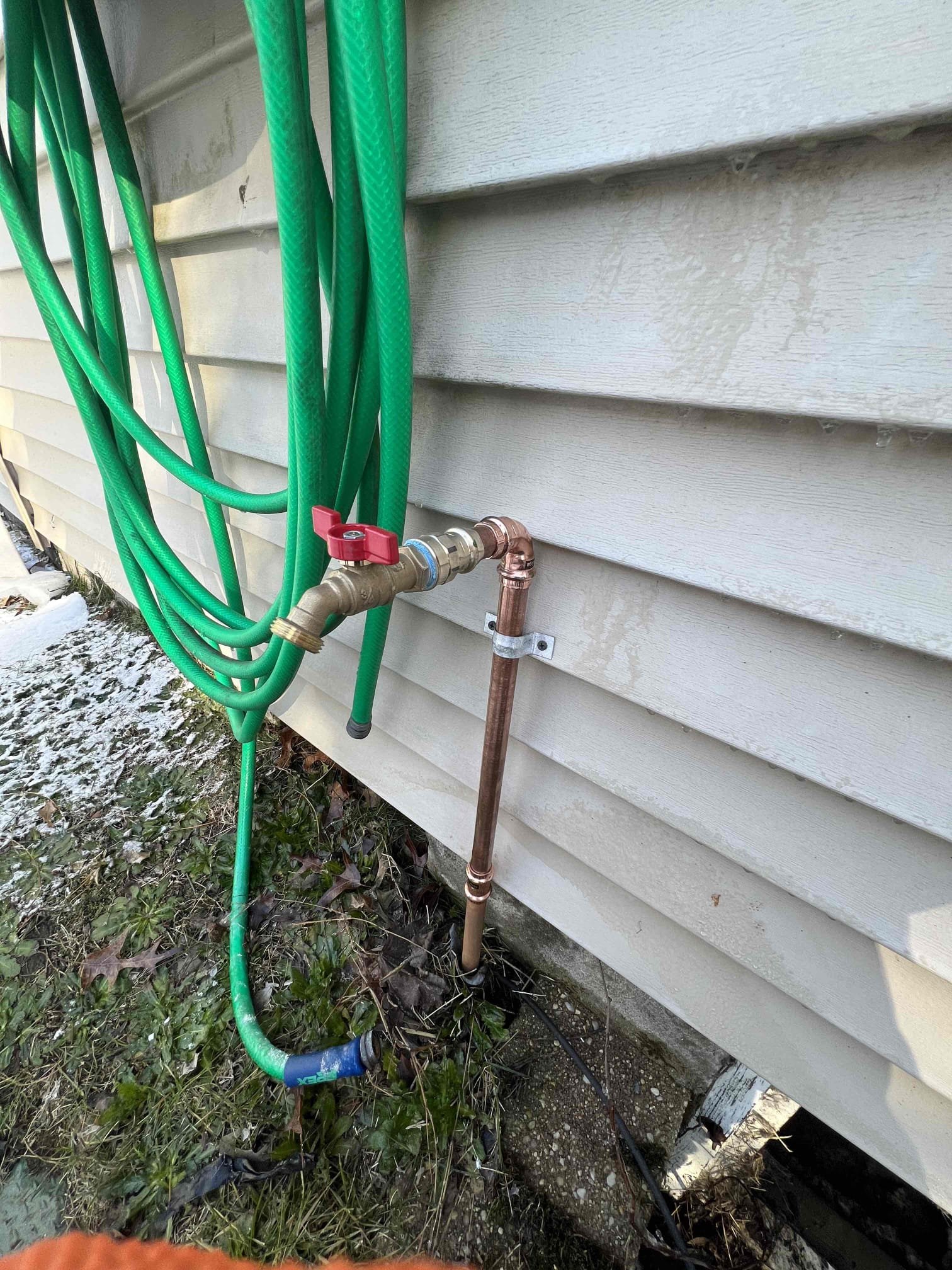 Cut out bursted pipe and add new boiler drain

Arrived on site client stated she had a leak outside. Upon inspection I saw the leak and turned the water off to that boiler drain outside. There is a ball valve for that hose spigot outside. Cut out existing boiler drain and added a new one. Strapped the new hose spigot as the old one was not strapped. There are no leaks at this time and advised customer to make not to leave the hose attached during the winter and to keep the water off until the weather gets warmer.