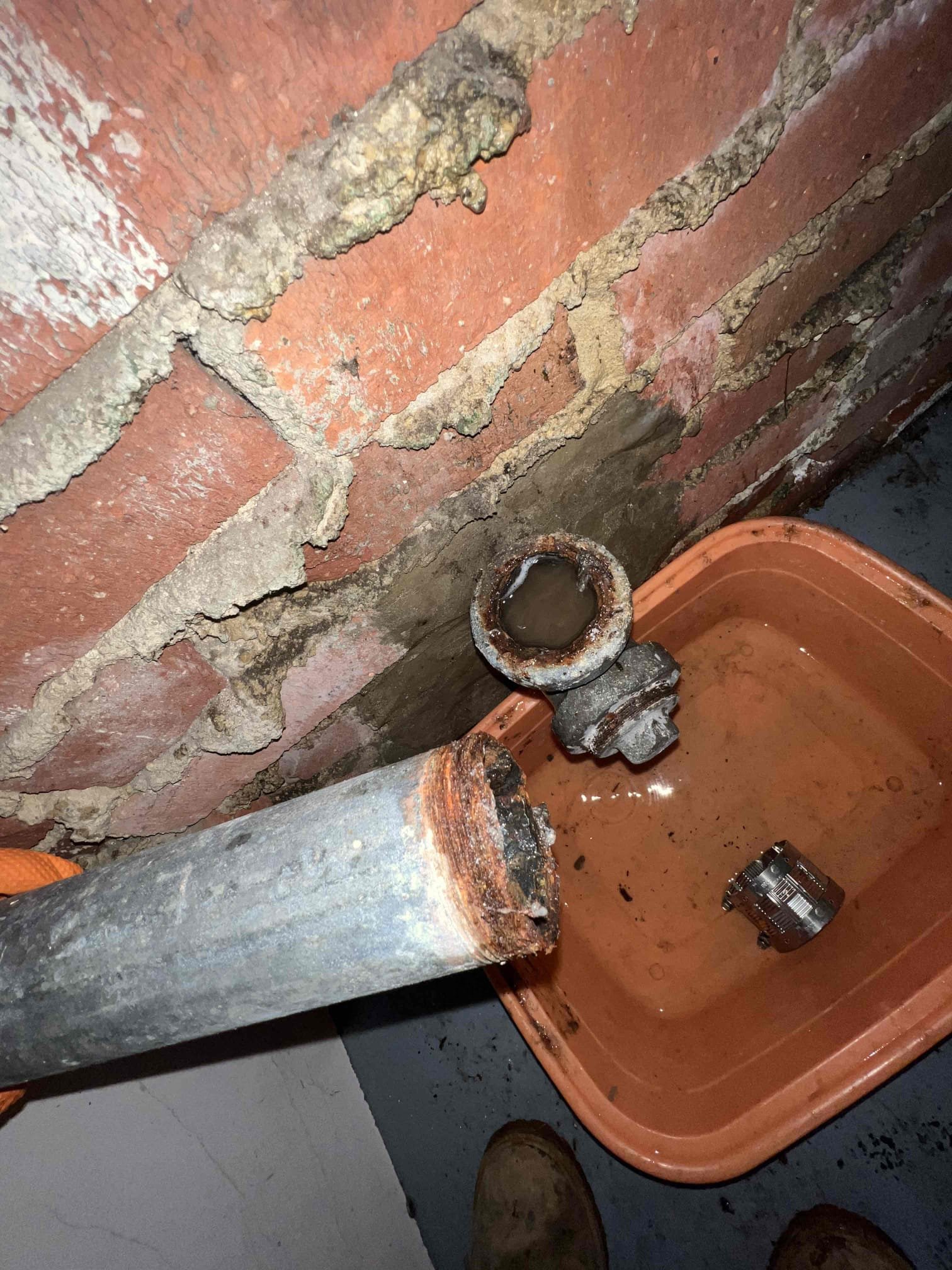 Arrived on site client state that they had a kitchen clog. Upon inspection in the garage thier were a few leaks coming from the kitchen drain. One leak was coming from a galvanized connection where the nipple just fell apart and was corroded. Attempted to snake the galvanized line but was unsuccessful. Told client that we should cut this section of piping out and in order to do so we need to use the chipping gun to remove some of the brick and pull the pipe out of the wall. We will return another day to perform work.