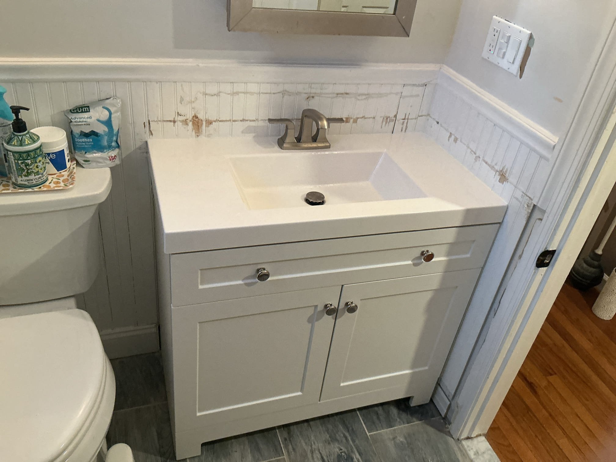 Client is completely aware that the wall will more than likely become damaged due to the existing vanity is held in place with construction adhesive. I am having the client sign off that they are okay with the demo.


-disconn3 Ted and removed existing vanity 
- supplied and installed new shut off valves, supply lines and new drainage 
- secured new vanity to the wall 
- added sealant for the top and secured connections
- made up drain and pressure tested drain for leaks
** are no leaks at this time 
- caulked vanity top as well 


* client is aware of my guy not being aware of any damages done to the wall 
* previous vanity was sealed together using liquid nail or construction adhesive.
* customer gave permission to remove vanity even if it meant causing damage to back wall
* parts and labor warranty only on rebuild underneath sink, cannot warranty customer supplied products, faucet and vanity.