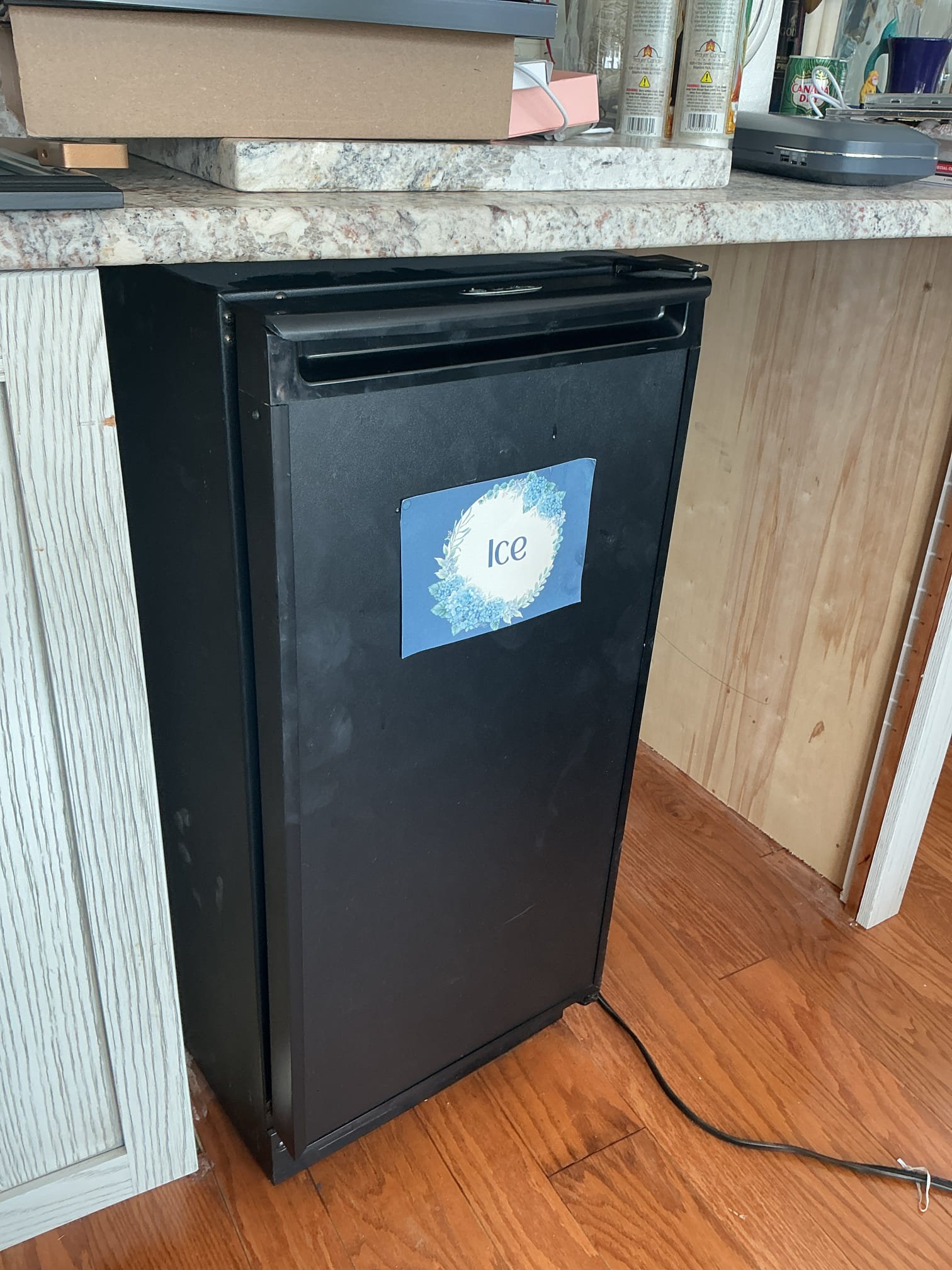 Arrived to the home, client has a leak from the second floor into the garage ceiling and they had shut off the water to the home, home is raised. I advised to the client to have us cut open the ceiling to further diagnose the issue. After cutting open the hole I discovered two drain piping above, one is the drain for the bar sink, the other is the condensate for the ice maker. It appears water was coming from the ice maker drain. I went back upstairs, removed the mini fridge and pushed the ice maker forward and the flex tube was leaking and about to flood the flooring in the room. I immediately ran down stairs and cut the condensate pipe to prevent anymore damages to the floor. I then traced back the condensate drain and the piping runs approximately 70ft to the other side on the home and into a sump pump pit. I discovered that the condensate drain had froze, not allowing any of the ice maker water to drain. The room that the condensate pipe is located has no heat and is not insulated.