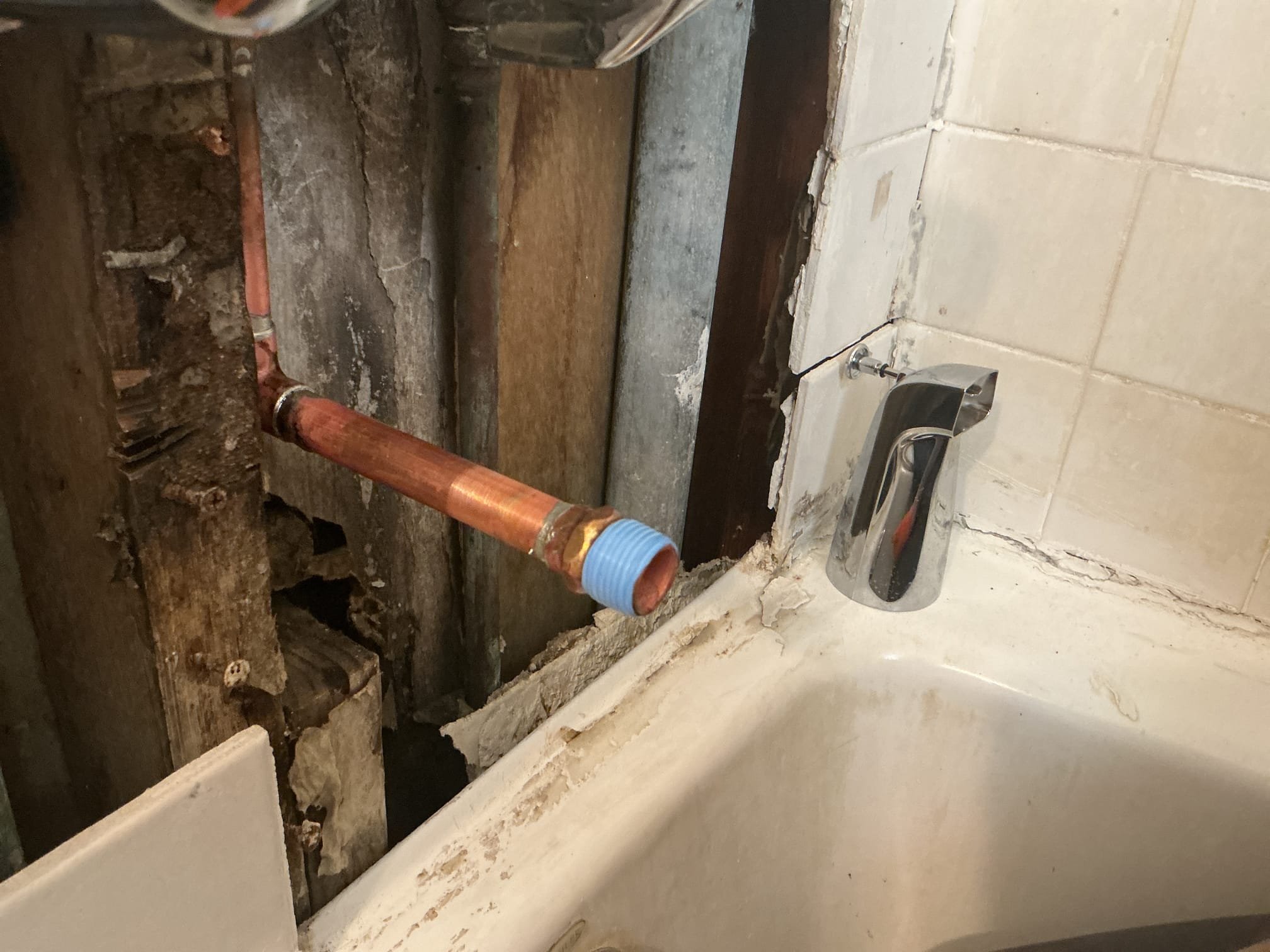 Arrived to the home, client states that their existing three handle shower valve does not divert the water from the tub spout to the shower head. When I arrived on site, client had stated that someone had try to replace the tub spout and ultimately the tiles had fell. The existing shower valve is in very rough shape and replacement is highly recommended. At this time the client would like use just to repair the stud out for the tub spout and get it prepped for the new tiles to be installed.

Unsoldered existing copper stub out.
Supplied and installed new copper pipe and fittings.
Soldered new connections and turned the shower on to check for leaks.
There are no leaks at this time.

*Can not warranty any customer supplied products.
