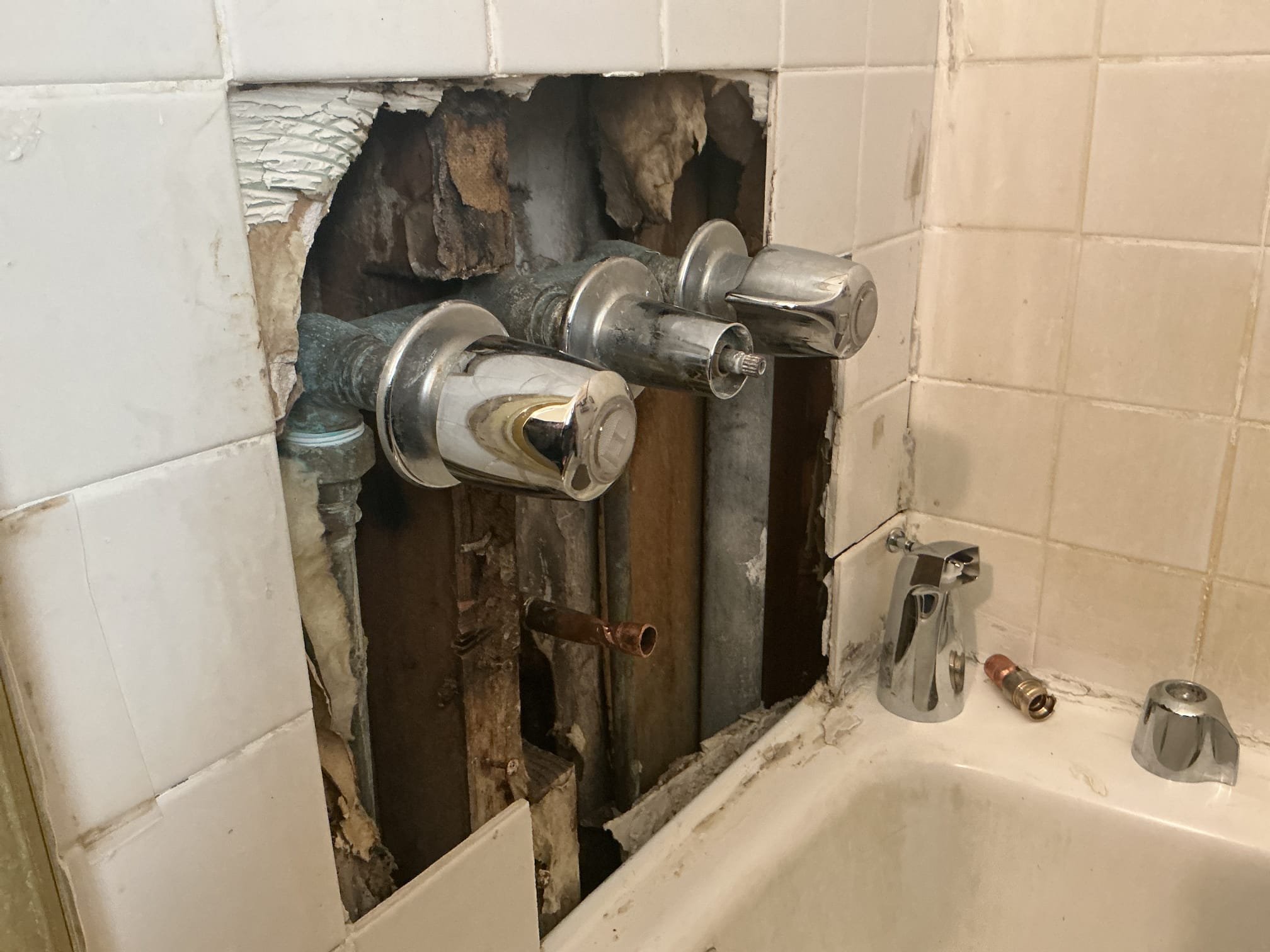 Arrived to the home, client states that their existing three handle shower valve does not divert the water from the tub spout to the shower head. When I arrived on site, client had stated that someone had try to replace the tub spout and ultimately the tiles had fell. The existing shower valve is in very rough shape and replacement is highly recommended. At this time the client would like use just to repair the stud out for the tub spout and get it prepped for the new tiles to be installed.

Unsoldered existing copper stub out.
Supplied and installed new copper pipe and fittings.
Soldered new connections and turned the shower on to check for leaks.
There are no leaks at this time.

*Can not warranty any customer supplied products.
