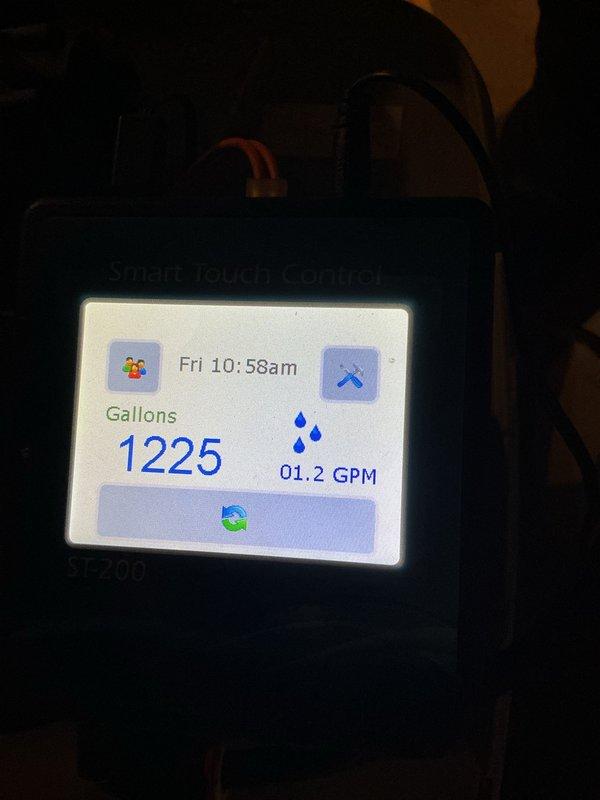 Successfully replaced Hague water treatment tank and installed new pressure reducing valve (PRV) after removing the existing lock on the water treatment system. System is now operational with proper flow rate (1.2 GPM) and pressure as verified through the Smart Touch Control panel (SF200 model).