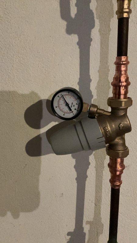 Successfully replaced Hague water treatment tank and installed new pressure reducing valve (PRV) after removing the existing lock on the water treatment system. System is now operational with proper flow rate (1.2 GPM) and pressure as verified through the Smart Touch Control panel (SF200 model).