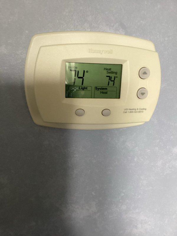 Performed routine maintenance on a 10-year-old gas heating system. Inspected burner assembly showing proper blue flame pattern and verified gas connections for safety. Confirmed Honeywell thermostat operation with system maintaining 74° setpoint in heat mode.