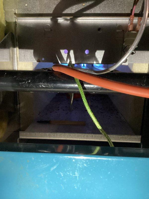 Performed routine maintenance on a 10-year-old gas heating system. Inspected burner assembly showing proper blue flame pattern and verified gas connections for safety. Confirmed Honeywell thermostat operation with system maintaining 74° setpoint in heat mode.