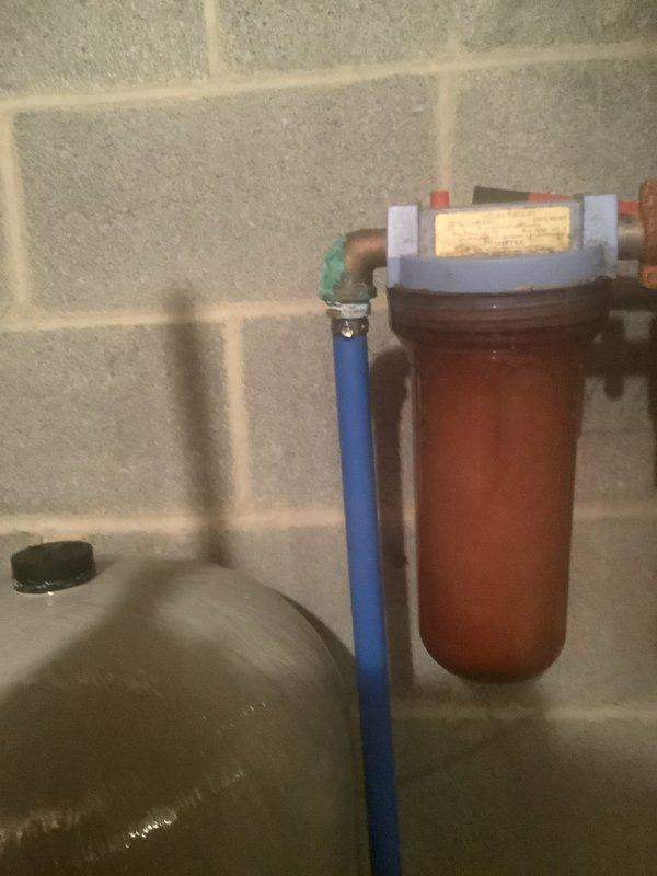 Responded to service call for water leak. Located leak at connection between copper fitting and PVC pipe near pressure tank/switch, evidenced by significant oxidation and verdigris formation. Repaired deteriorated fittings and restored proper function to water system with filtration components.