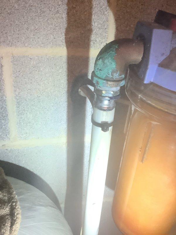 Responded to service call for water leak. Located leak at connection between copper fitting and PVC pipe near pressure tank/switch, evidenced by significant oxidation and verdigris formation. Repaired deteriorated fittings and restored proper function to water system with filtration components.
