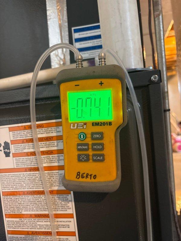 Responded to service call for a Moyer Comfort Series LP furnace experiencing error codes LO11 and F13 (restricted air flow). Inspected burner assembly which showed significant debris accumulation in lower ports. Used UEi EM201B pressure meter to verify proper gas pressure readings. Cleaned burner assembly ports and verified proper system operation with no error codes present.