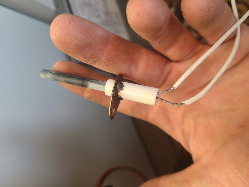 Responded to after-hours emergency call for heating system failure. Diagnosed faulty ignition electrode preventing proper flame ignition. Replaced ignition electrode and verified proper flame pattern and combustion in burner assembly, restoring system to normal operation.