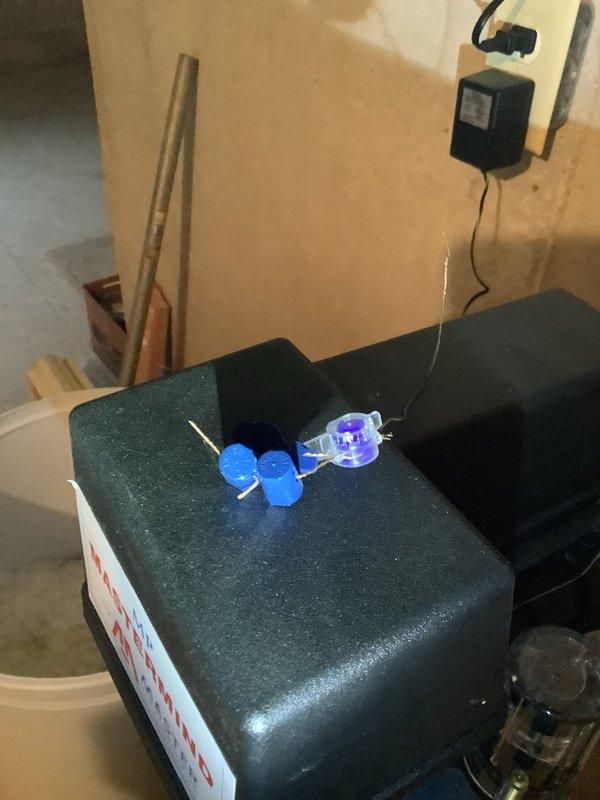 Diagnosed water treatment system with customer complaint of minimal salt consumption and hard water spots. Inspected Master water softener unit which showed illuminated flow indicator light but minimal salt depletion. Examined control valve and electronic components including circuit board with blue cylindrical components and purple indicator light. System appears properly installed but not functioning correctly; customer is monitoring situation with follow-up service potentially required.