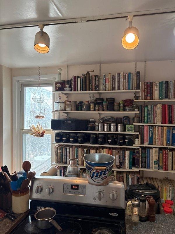 Responded to emergency call regarding ceiling water leak that had progressed to a large bulge threatening to burst. Upon arrival, found active leak producing yellowish water with soap-like bubbles, requiring constant bucket emptying. Identified and repaired faulty plumbing connection in upstairs bathroom that was causing water to accumulate in kitchen ceiling above bookshelves and stove area.