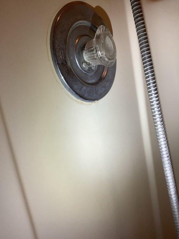 Responded to service call for ceiling leak originating from upstairs shower. Inspection revealed significant water damage and deterioration to the cabinet floor beneath plumbing fixtures, with visible moisture intrusion affecting the surrounding materials. Identified failed shower valve as the source of the leak and scheduled return visit with replacement part to complete the repair.