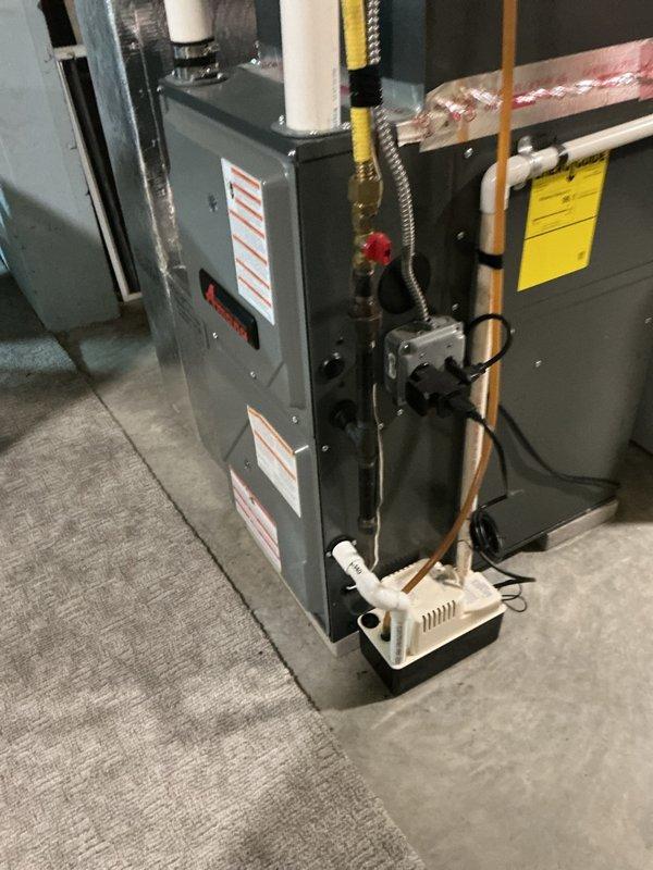Responded to service call for a Rheem 50-gallon natural gas water heater reported to be leaking from the drain valve area. Upon inspection, identified internal drain valve failure as the source of leakage rather than tank corrosion. Replaced defective drain valve and verified proper operation of the Honeywell control unit, ensuring system was functioning correctly before customer's scheduled departure.