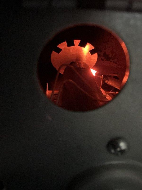 Responded to no-heat call for propane furnace that was attempting to start but failing to ignite properly. Inspection revealed ignition system issues, successfully cleaned and adjusted burner assembly to restore proper flame pattern. System now operating normally with strong blue/orange flame visible through inspection port.