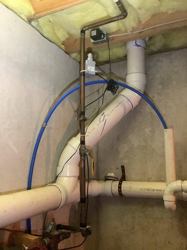 Completed comprehensive plumbing inspection of basement utility area, examining exposed PVC drainage system, copper supply lines, and dual water treatment units. Verified proper installation of pipe mounting brackets, connection integrity at all joints, and functionality of control valve assembly. Inspection was coordinated with heating system evaluation.