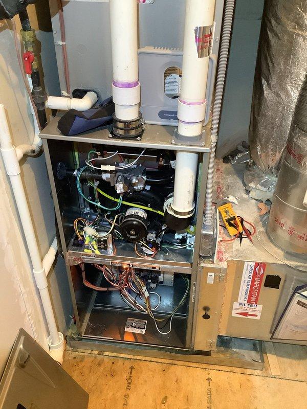 Performed comprehensive inspection on 2-year-old Carrier natural gas heating system with zoning issues. Examined internal components including motor assembly, electrical wiring, and control systems. Identified significant temperature differential between floors (89°F in upstairs loft vs 72°F downstairs) and inspected Honeywell smart thermostat that had previously malfunctioned. Observed filter drier component with copper piping showing signs of corrosion that may be contributing to the zoning performance problems.