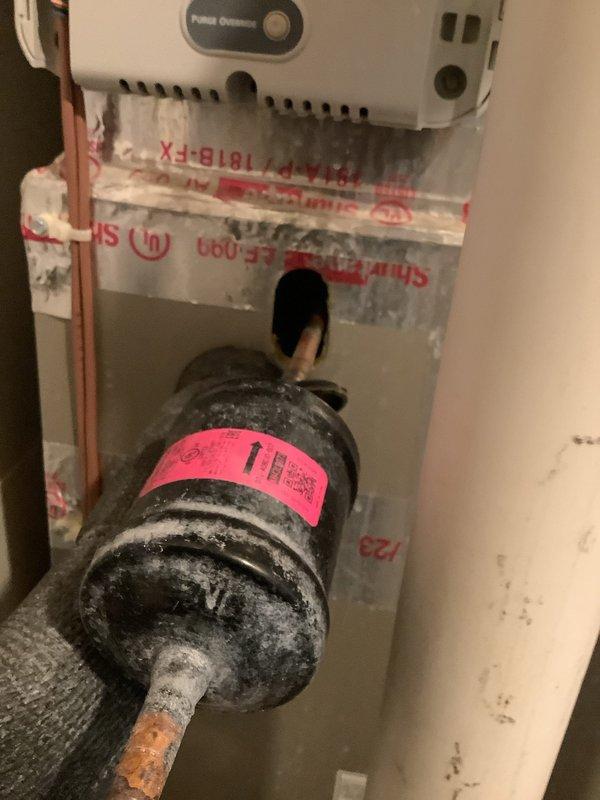 Performed comprehensive inspection on 2-year-old Carrier natural gas heating system with zoning issues. Examined internal components including motor assembly, electrical wiring, and control systems. Identified significant temperature differential between floors (89°F in upstairs loft vs 72°F downstairs) and inspected Honeywell smart thermostat that had previously malfunctioned. Observed filter drier component with copper piping showing signs of corrosion that may be contributing to the zoning performance problems.