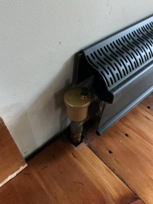 # Heating System Repair - Dining Room Baseboard Loop

Drained the heating loop serving the dining room baseboard unit to address reported leaks. Inspected all fittings and connections along the affected zone, including the brass control valve assembly and associated piping. Repaired leaking fittings by tightening connections and replacing compromised components as needed. Verified integrity of copper piping runs in basement where the loop originates, checking all T-joints and brass fittings for proper sealing. Refilled the heating loop, purged air from the system, and pressure-tested all repaired connections to ensure leak-free operation. Confirmed proper flow through the baseboard unit and verified control valve functionality before returning system to service.